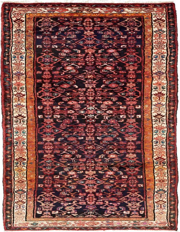 A 10 ft runner rug in a traditional Persian tribal pattern, featuring a deep navy blue field with intricate red, orange, and cream motifs, perfect for a hallway.