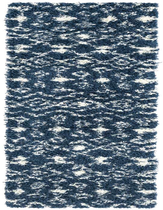 A long 8 ft runner rug with a navy blue and white tribal pattern, featuring a plush shag pile.