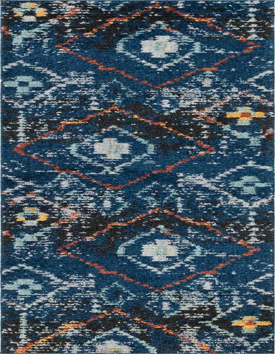 A 10 ft runner rug in a rich navy blue with a distressed bohemian pattern featuring orange, black, and light blue accents.