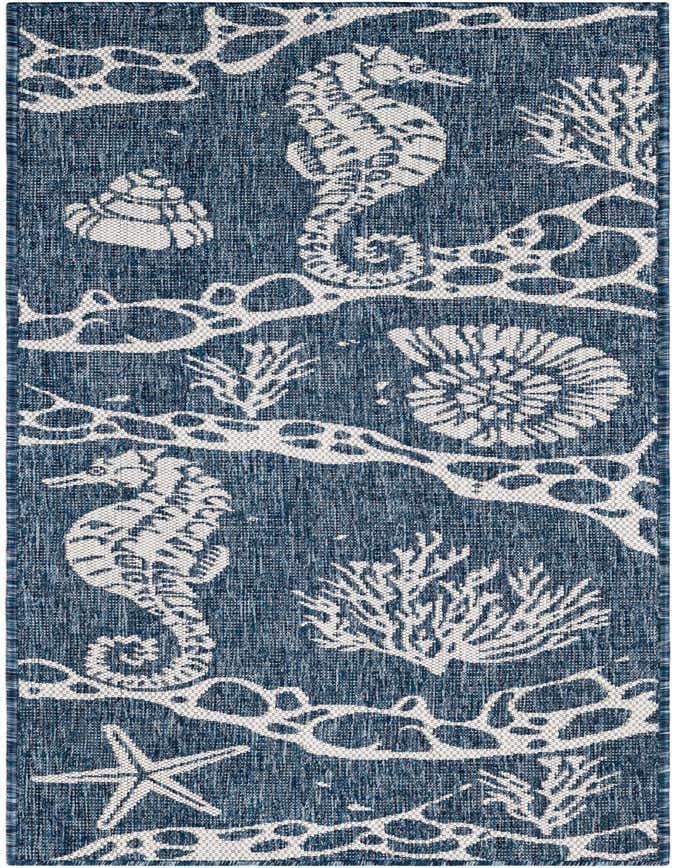 A navy blue and white runner rug with a coastal pattern featuring seahorses, starfish, seashells, and coral.