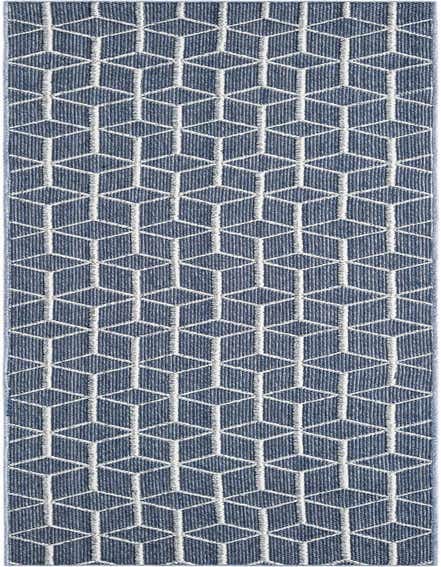 A long navy blue runner rug with a repeating white geometric trellis pattern, suitable for a hallway or patio.
