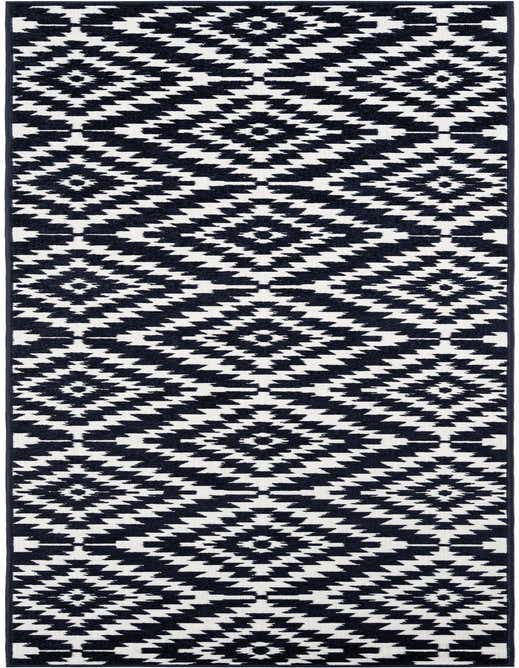 A 10 ft runner rug featuring a modern geometric pattern of alternating navy blue and white diamonds, suitable for a hallway or patio.