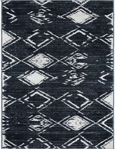 A long, thin navy blue runner rug with an abstract modern pattern of distressed white geometric shapes, ideal for a hallway.