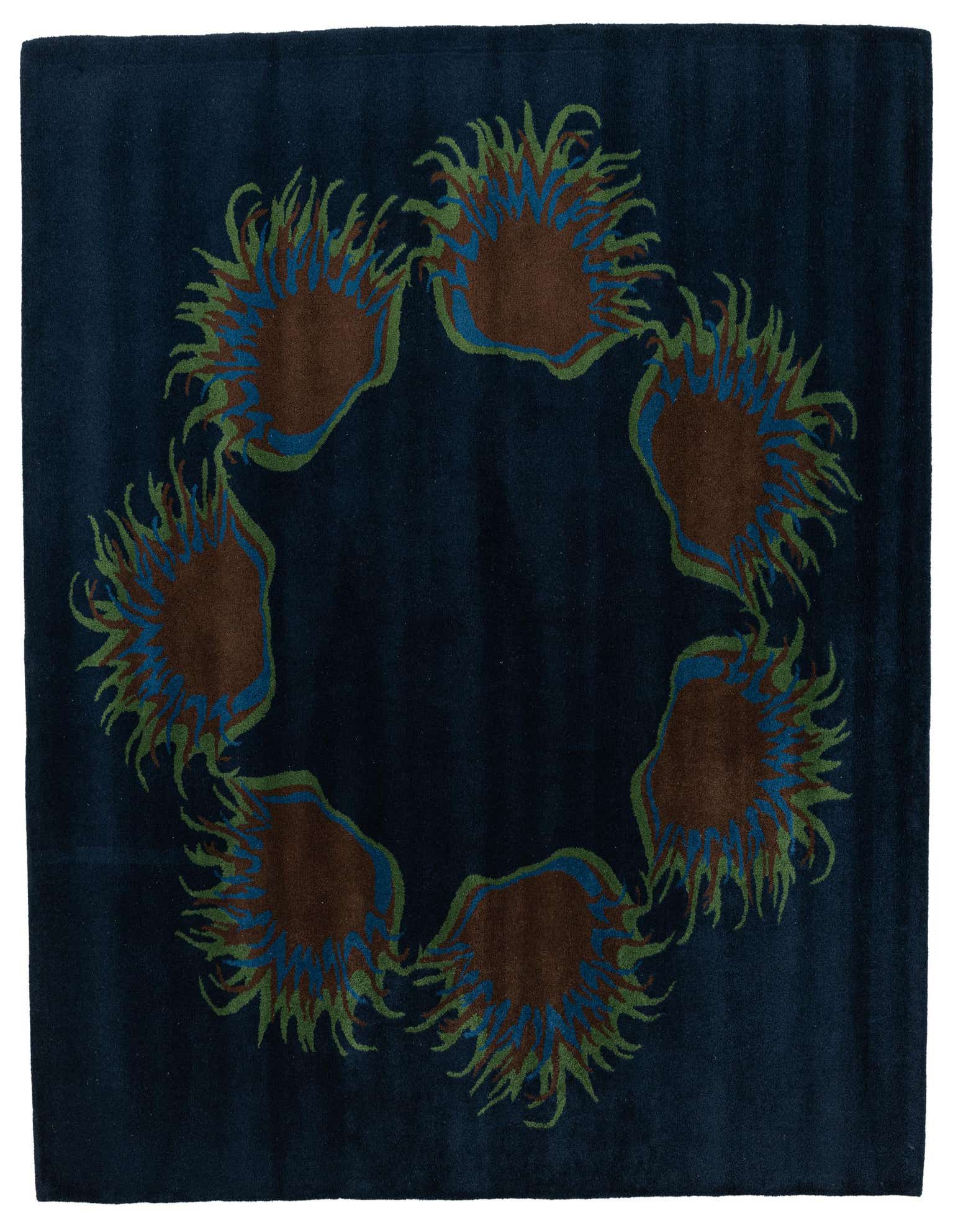A square navy blue wool rug featuring a circular pattern of abstract brown, green, and blue floral motifs.