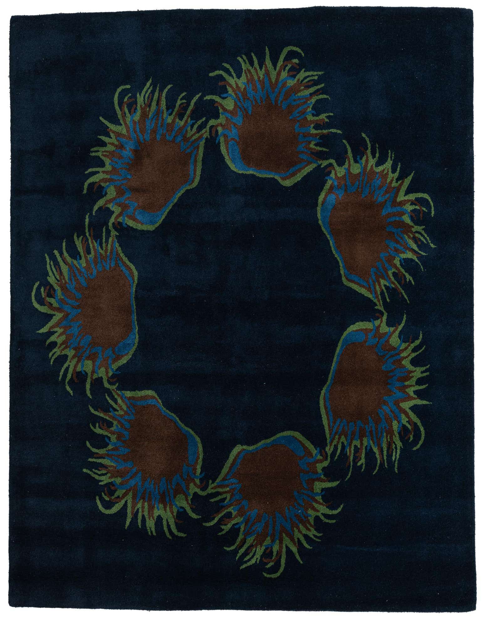 A square navy blue wool rug featuring a circular pattern of brown, blue, and green floral bursts.