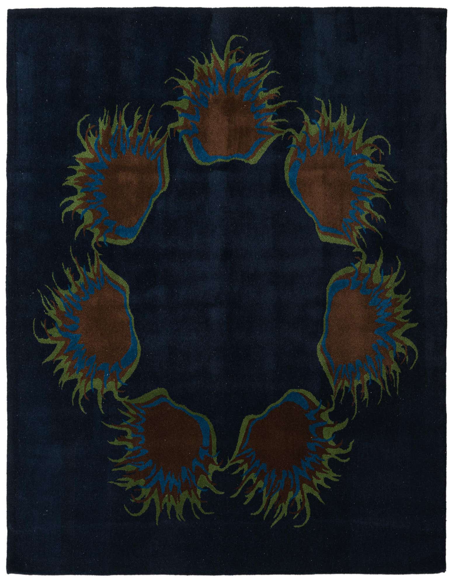 A square navy blue rug with a circular floral design featuring brown, blue, and green botanical elements.