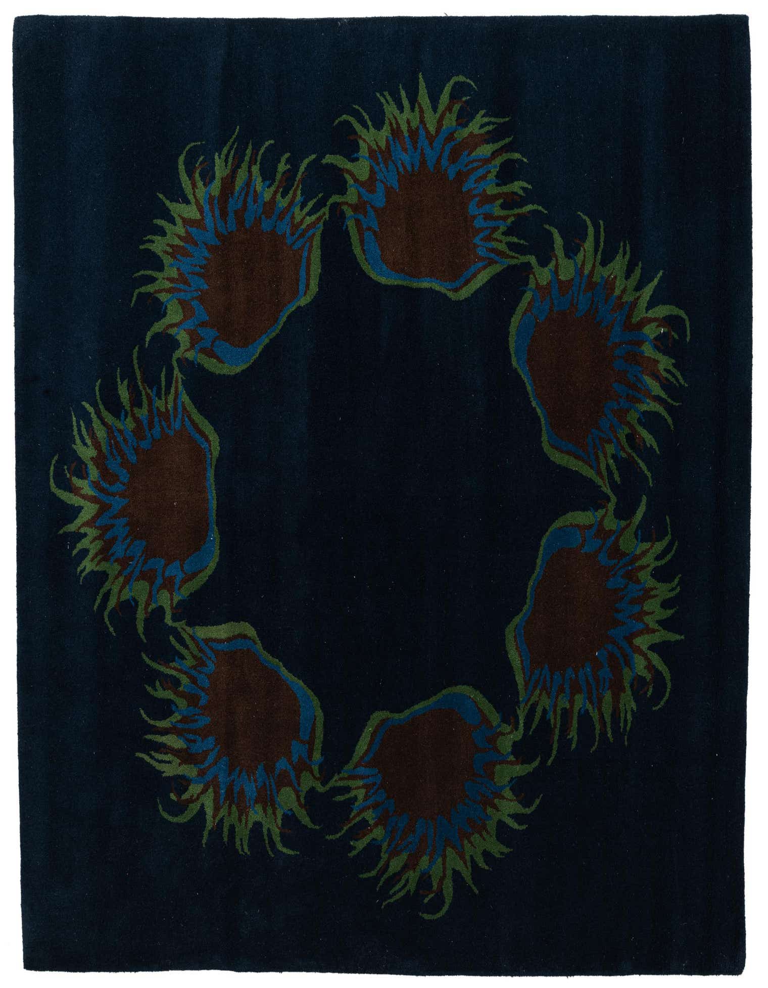 A navy blue square wool rug with a circular pattern of abstract brown, blue, and green floral motifs.