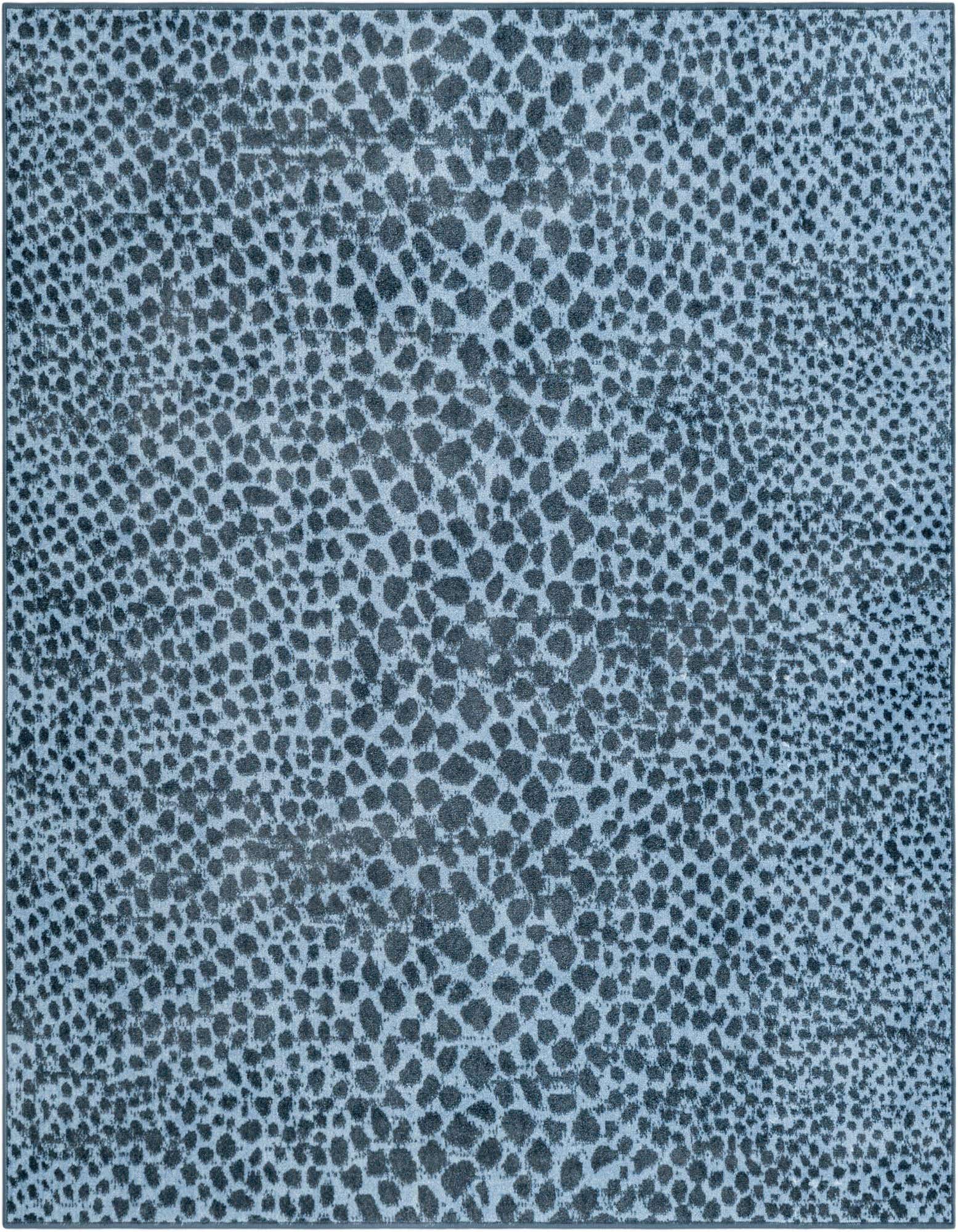 A 5' 3 x 5' 3 square Kamala Washable rug featuring a modern abstract pattern in varying shades of blue.
