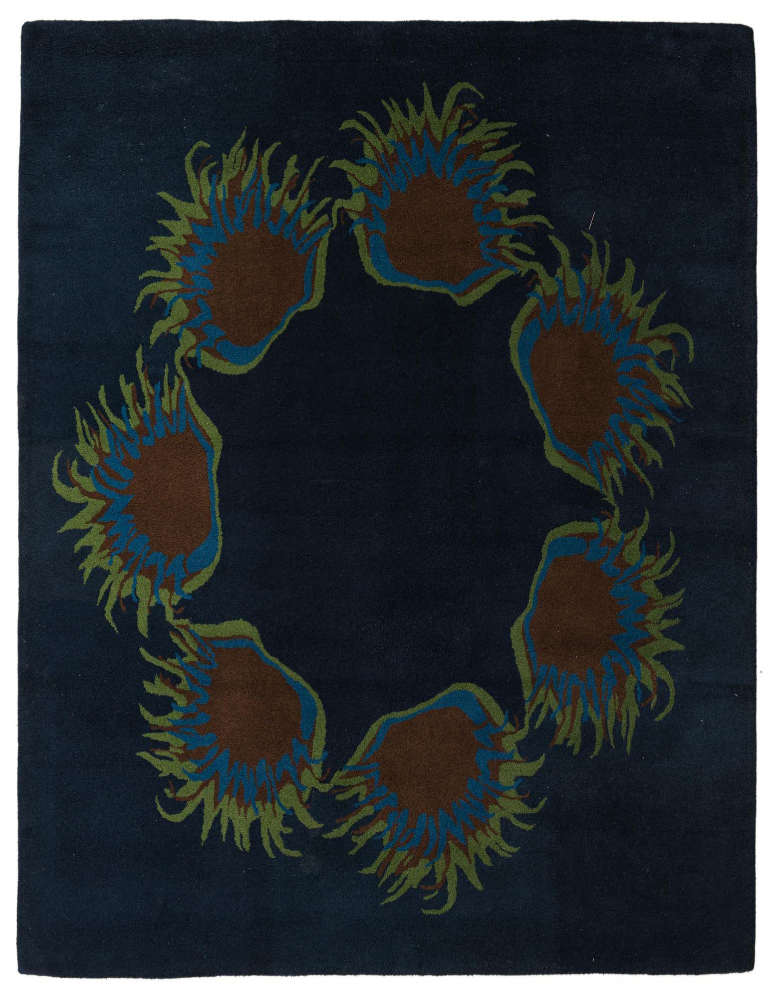 A square navy blue rug with a modern circular pattern of abstract brown, blue, and green shapes.