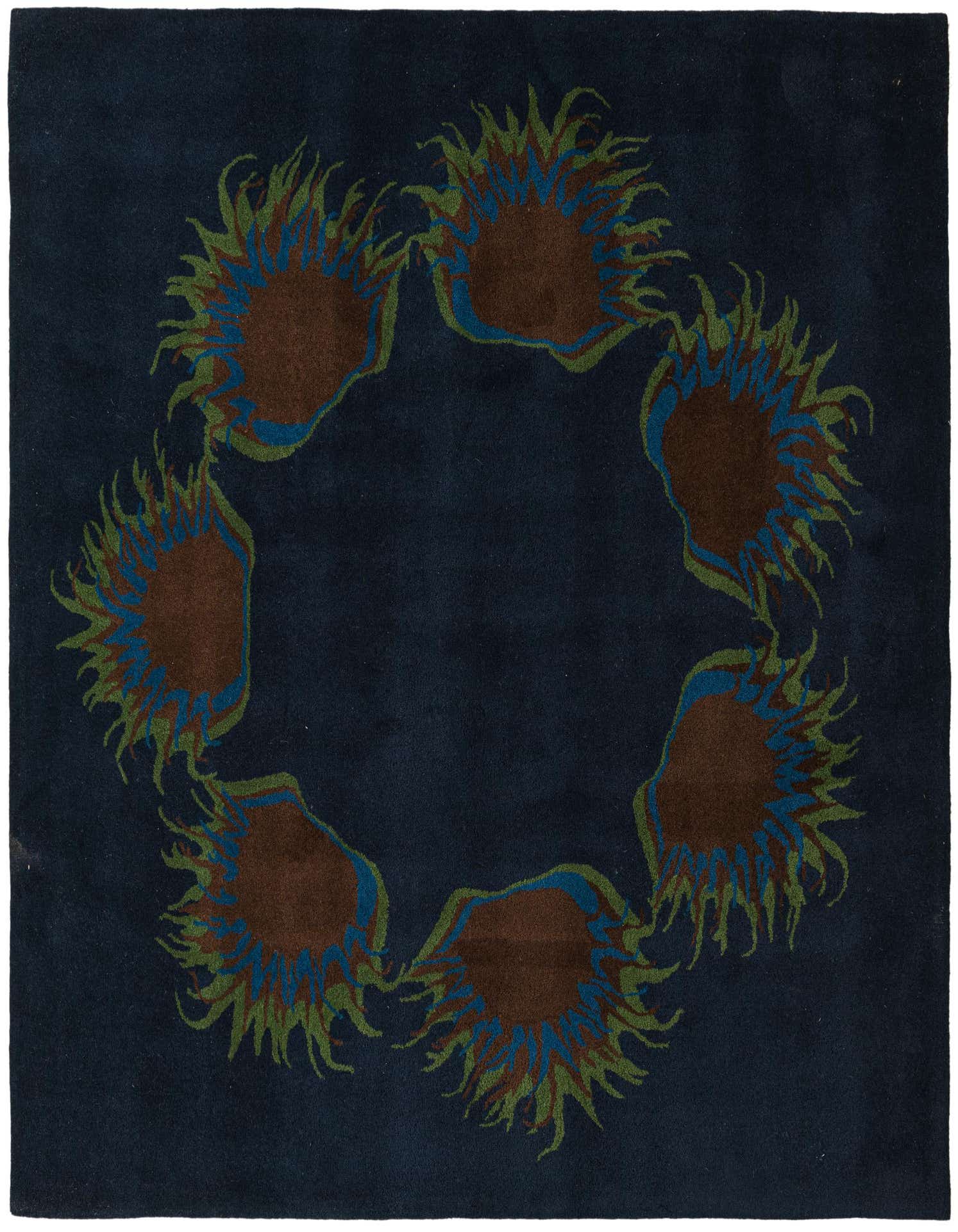 A square navy blue rug with an abstract circular pattern of brown, blue, and green spiky shapes.