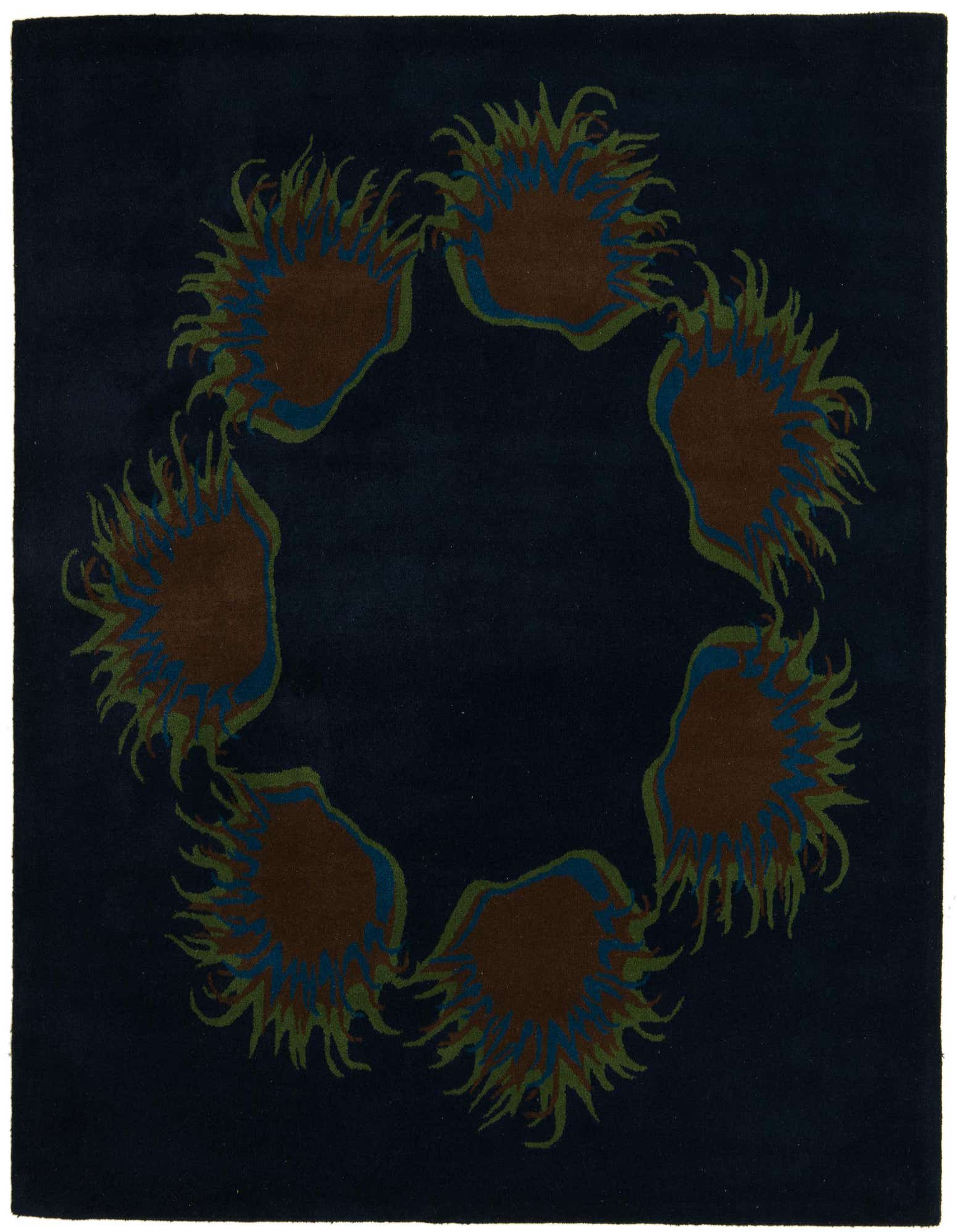 A square navy blue modern rug with a circular floral pattern of brown, green, and blue abstract shapes.