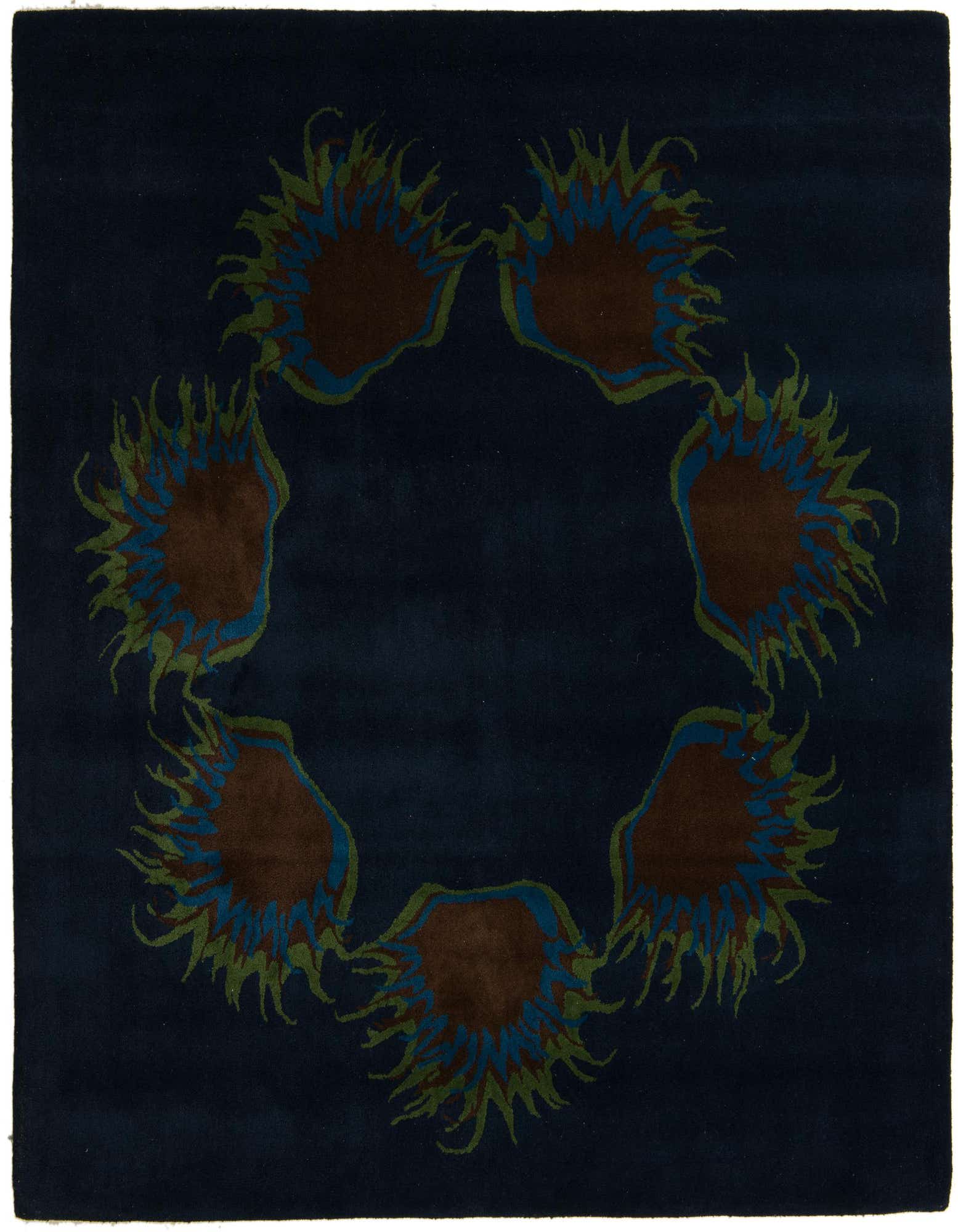 A square navy blue modern rug featuring a circular arrangement of abstract floral motifs in brown, blue, and green.