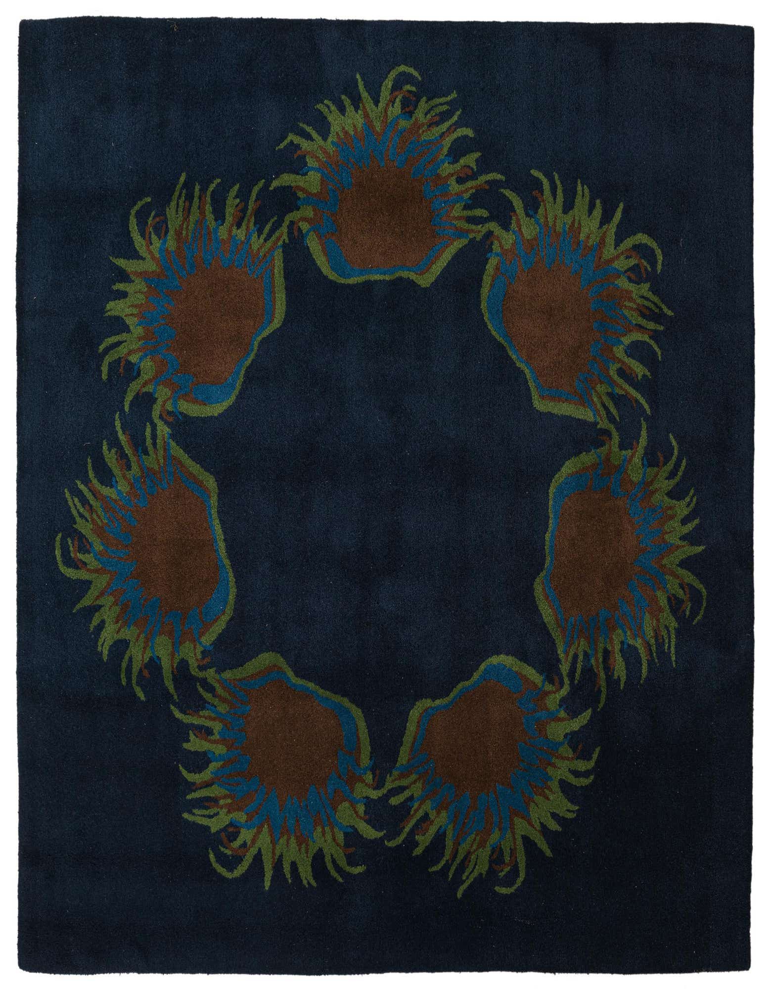 A square navy blue rug with a circular floral pattern featuring brown, blue, and green botanical shapes.