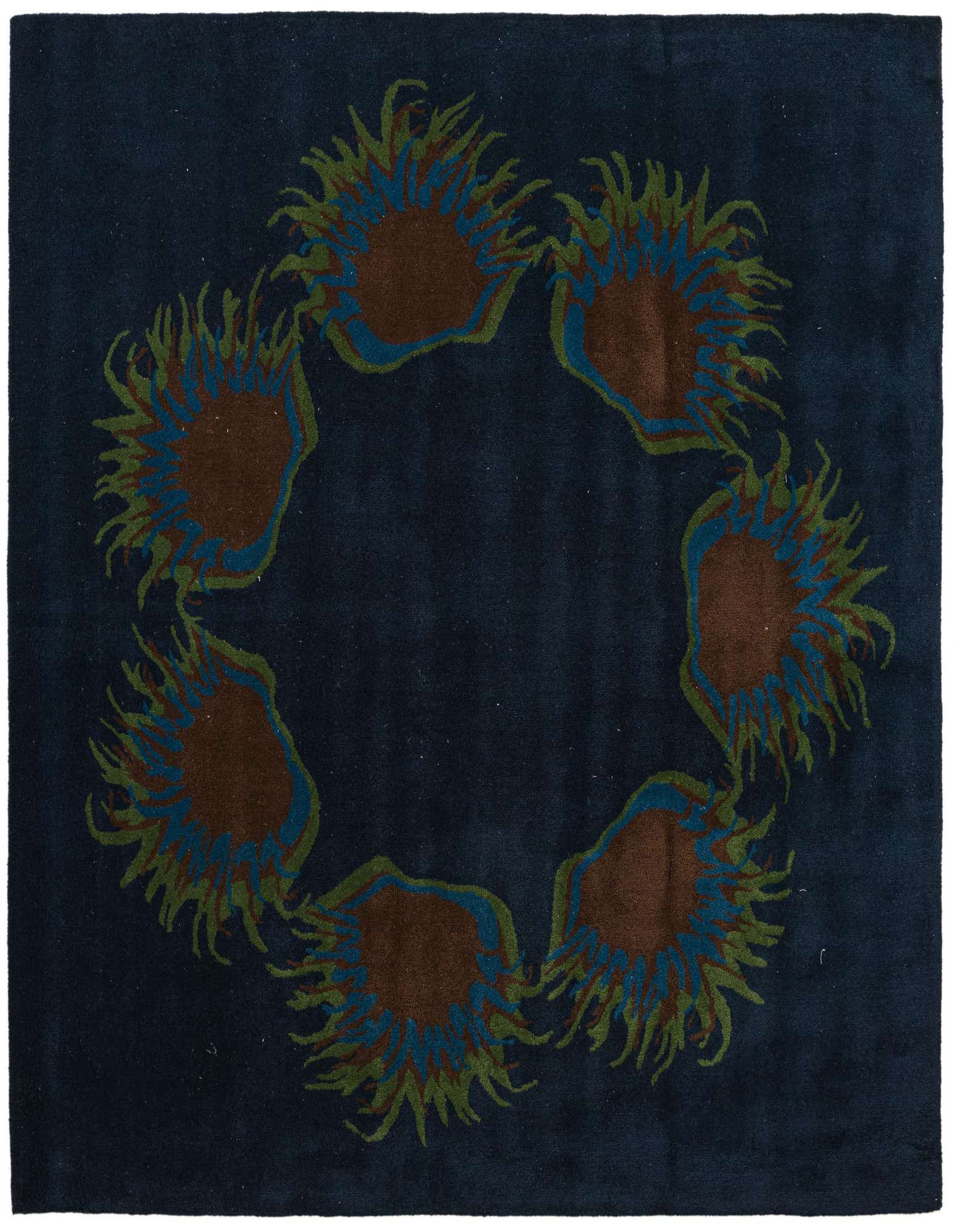 A 7' 7 x 7' 7 square navy blue wool rug with a circular floral pattern featuring brown, green, and blue petals.