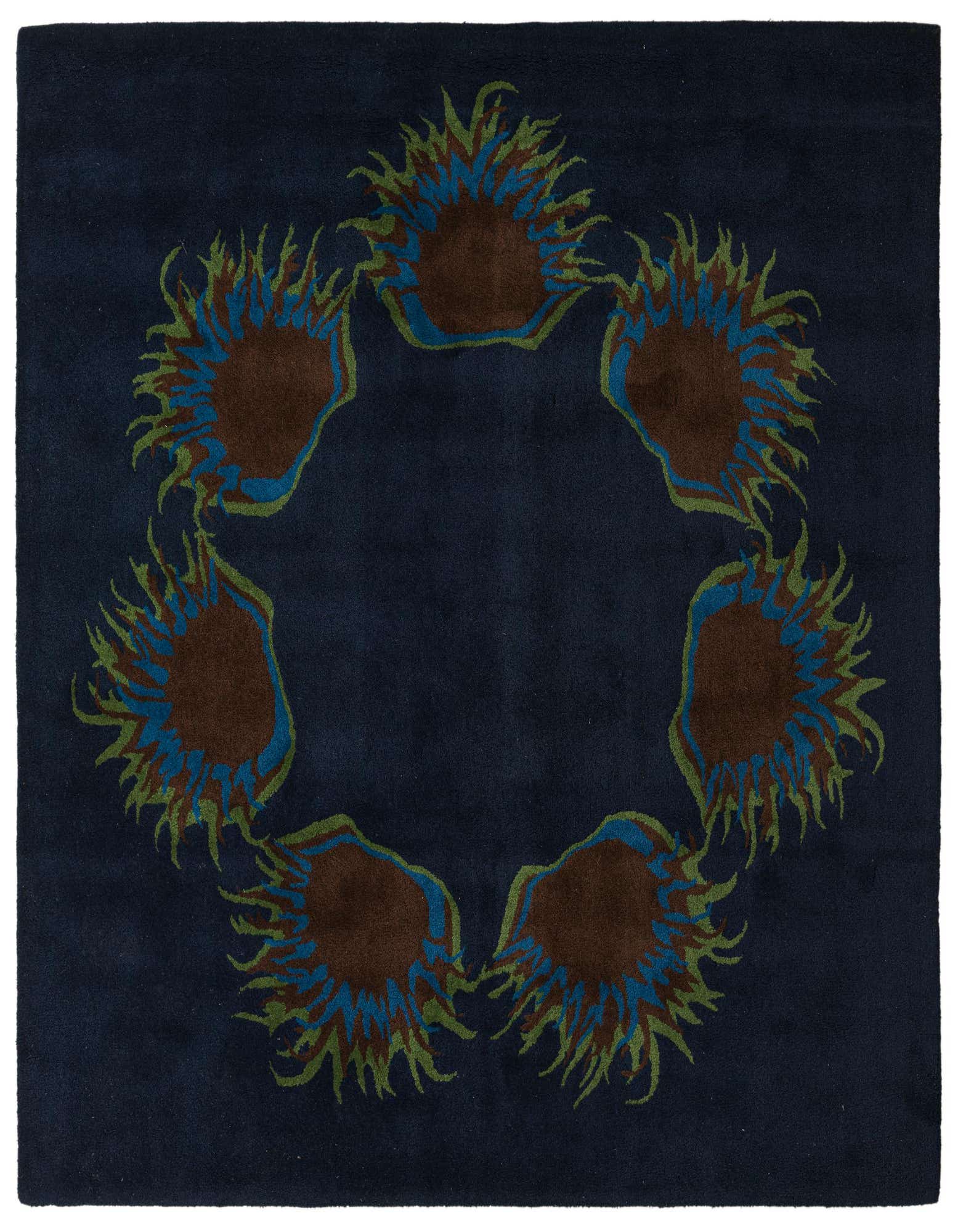 A square navy blue rug with a circular floral pattern of brown, blue, and green abstract flowers.