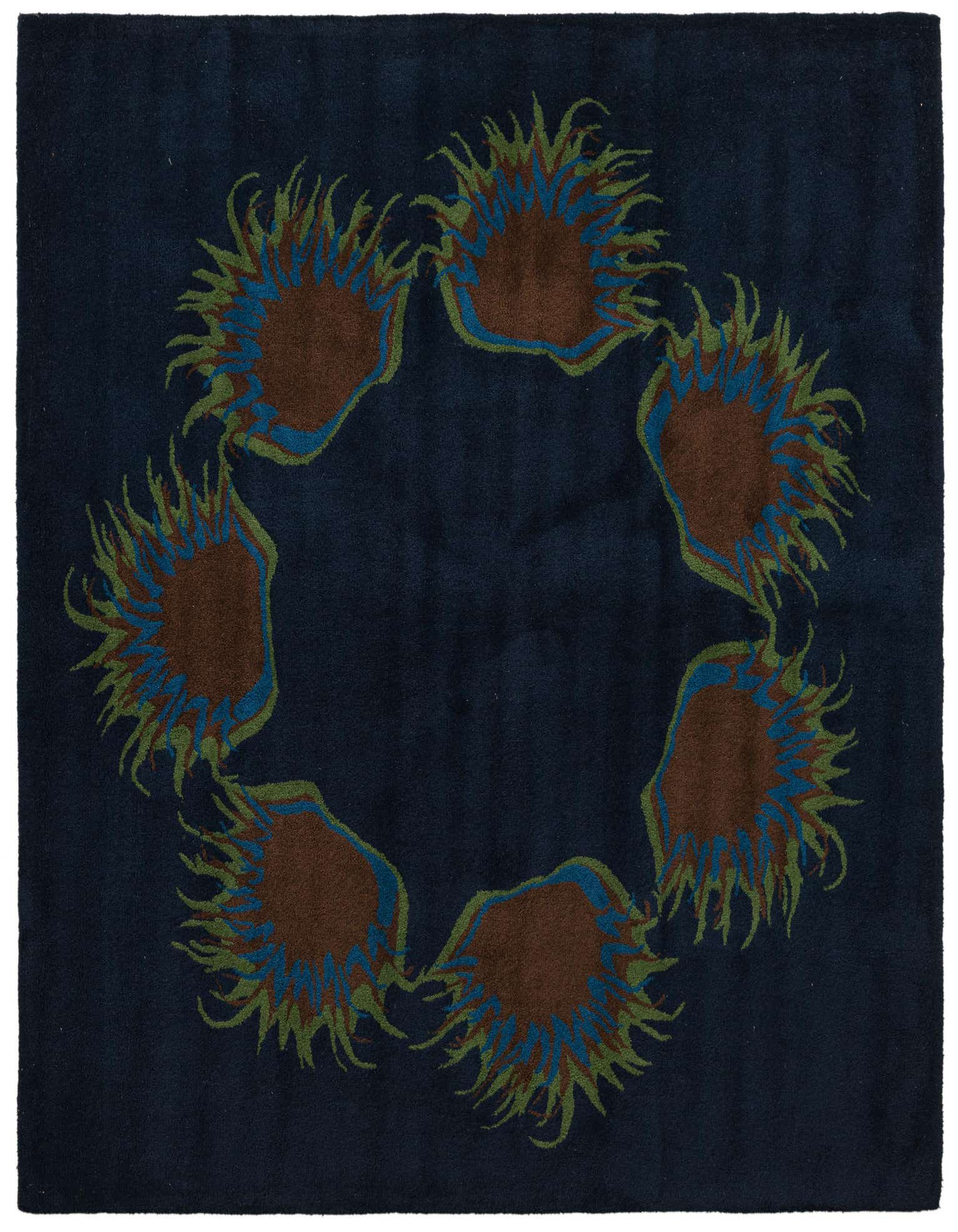 A square navy blue rug with a circular floral pattern of brown, blue, and green spiky shapes.
