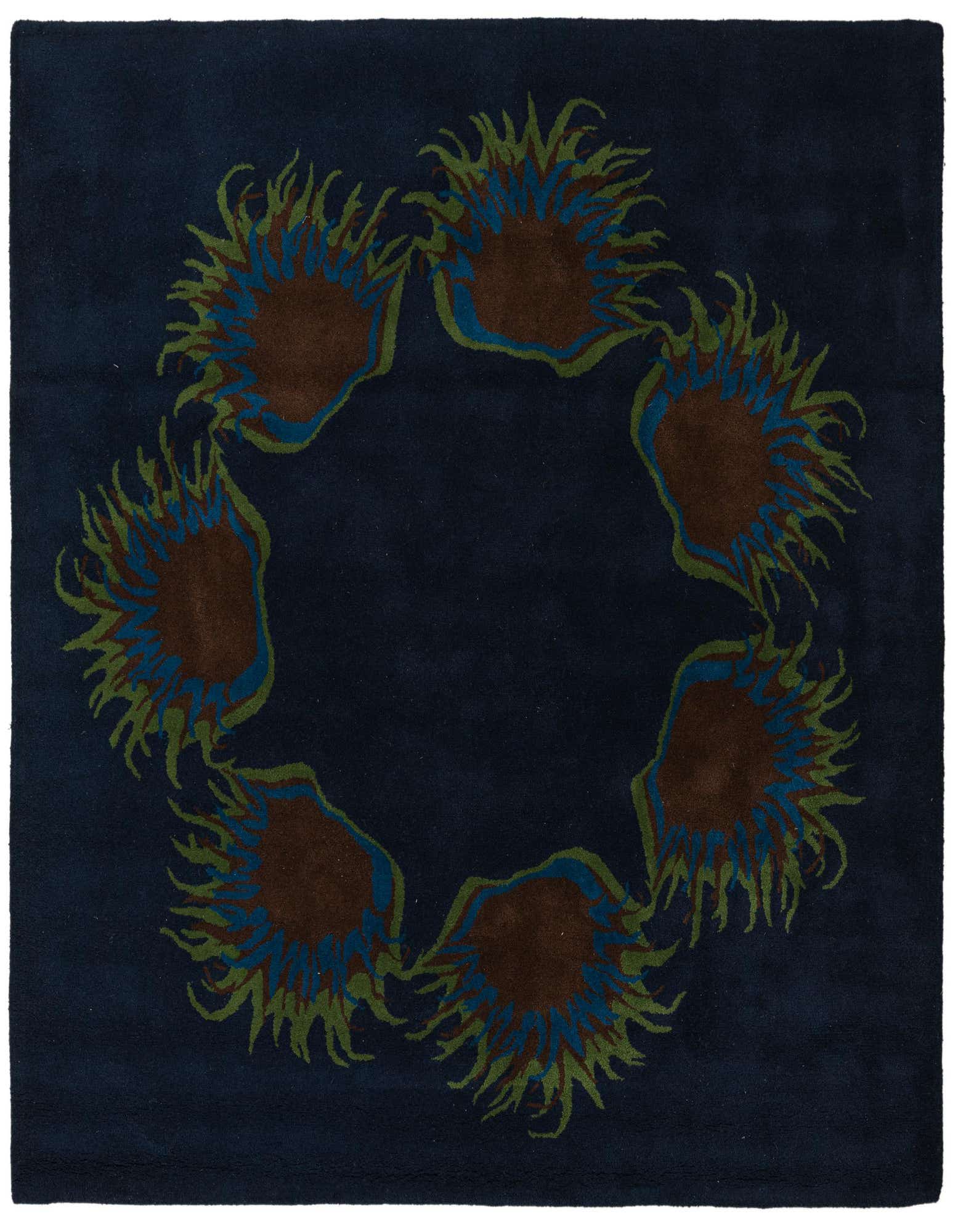 A square navy blue rug with a circular floral pattern of brown, blue, and green botanical shapes.