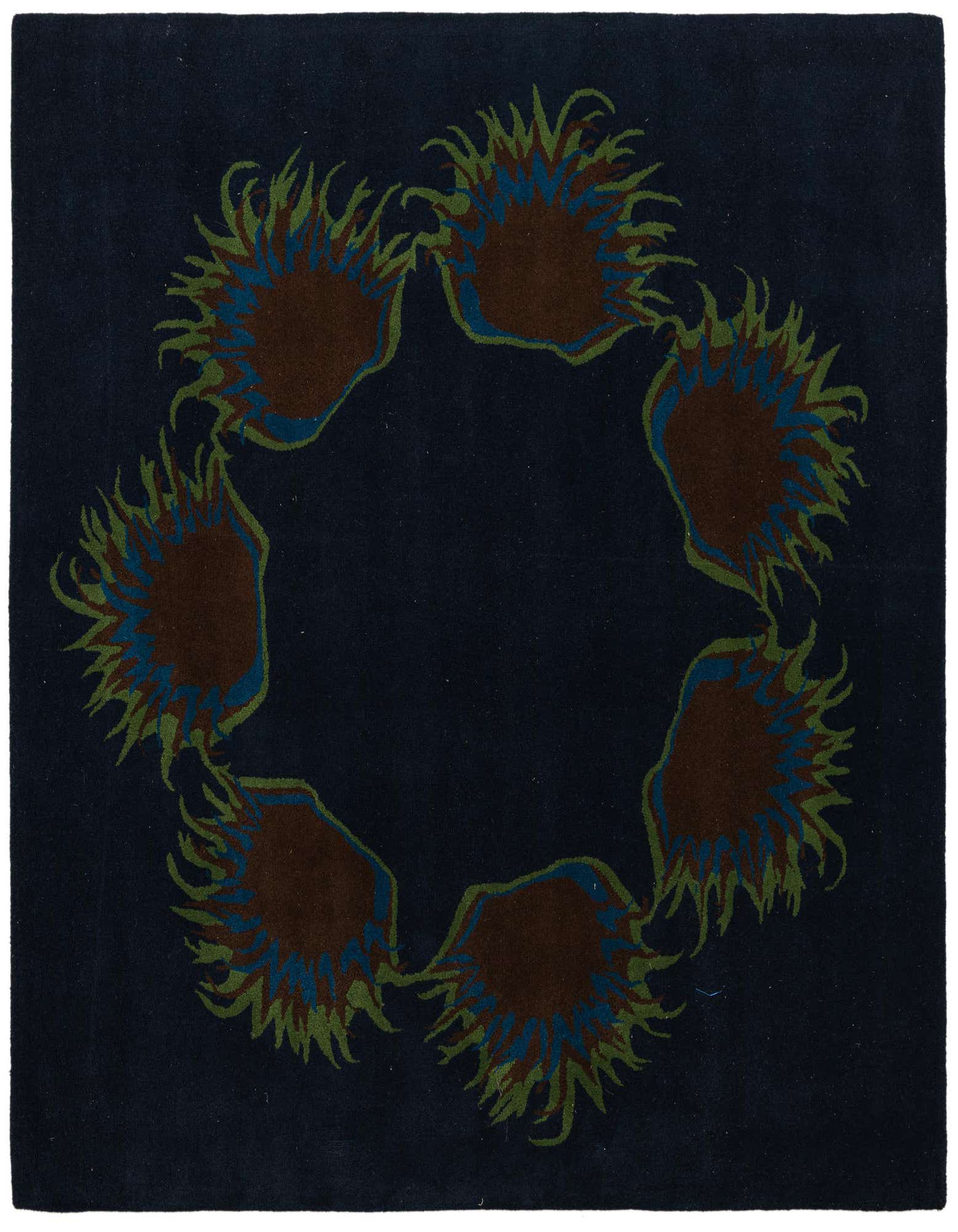 A square navy blue wool and cotton rug with a circular floral pattern of brown, green, and blue petals.