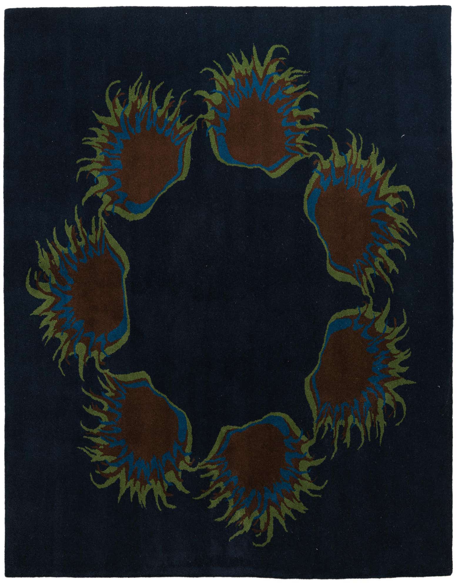 A square navy blue wool and cotton rug with a circular floral pattern featuring brown, green, and blue accents.