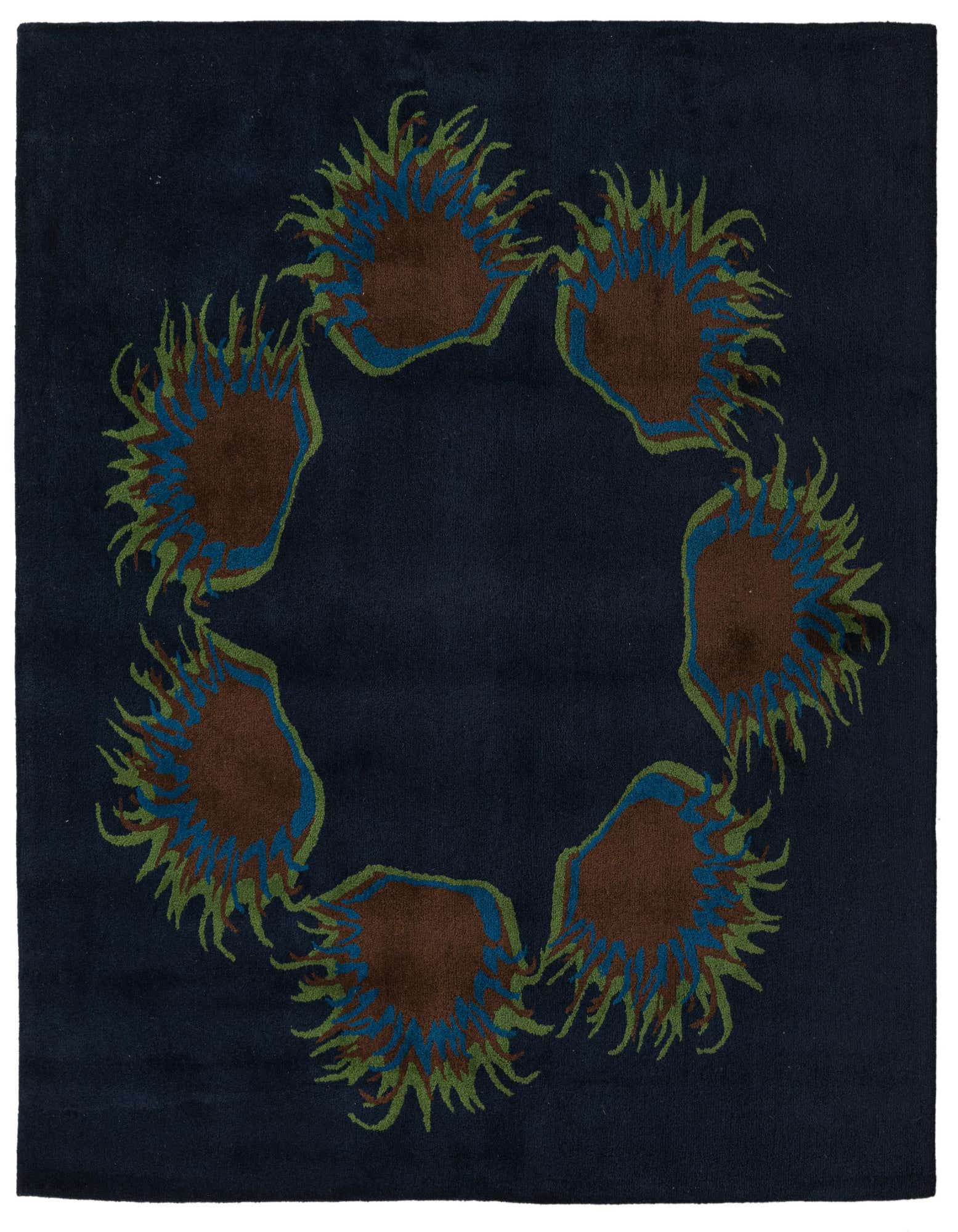 A square navy blue rug featuring a circular arrangement of six brown, blue, and green floral/botanical motifs.