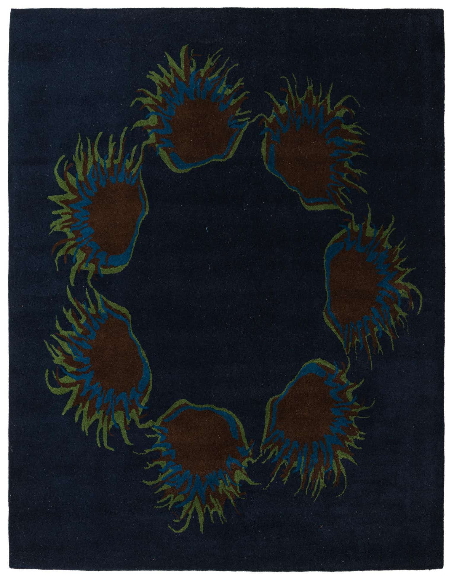 A square navy blue rug with a circular floral pattern of brown, blue, and green botanical shapes.
