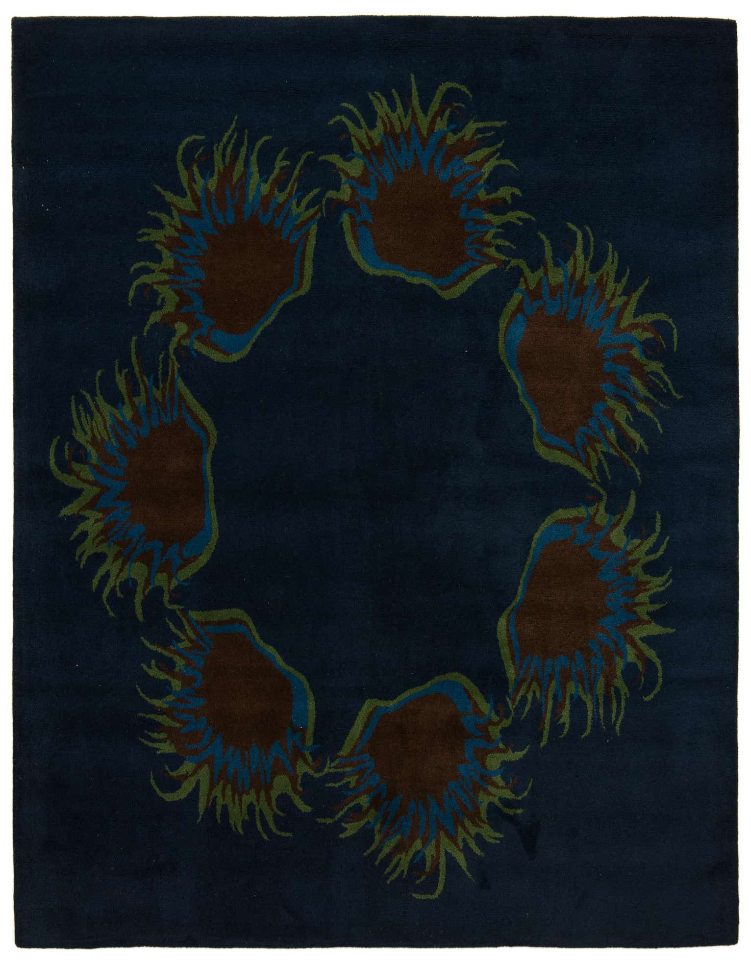 A square navy blue rug with a modern floral pattern featuring brown, blue, and green abstract shapes arranged in a circle.