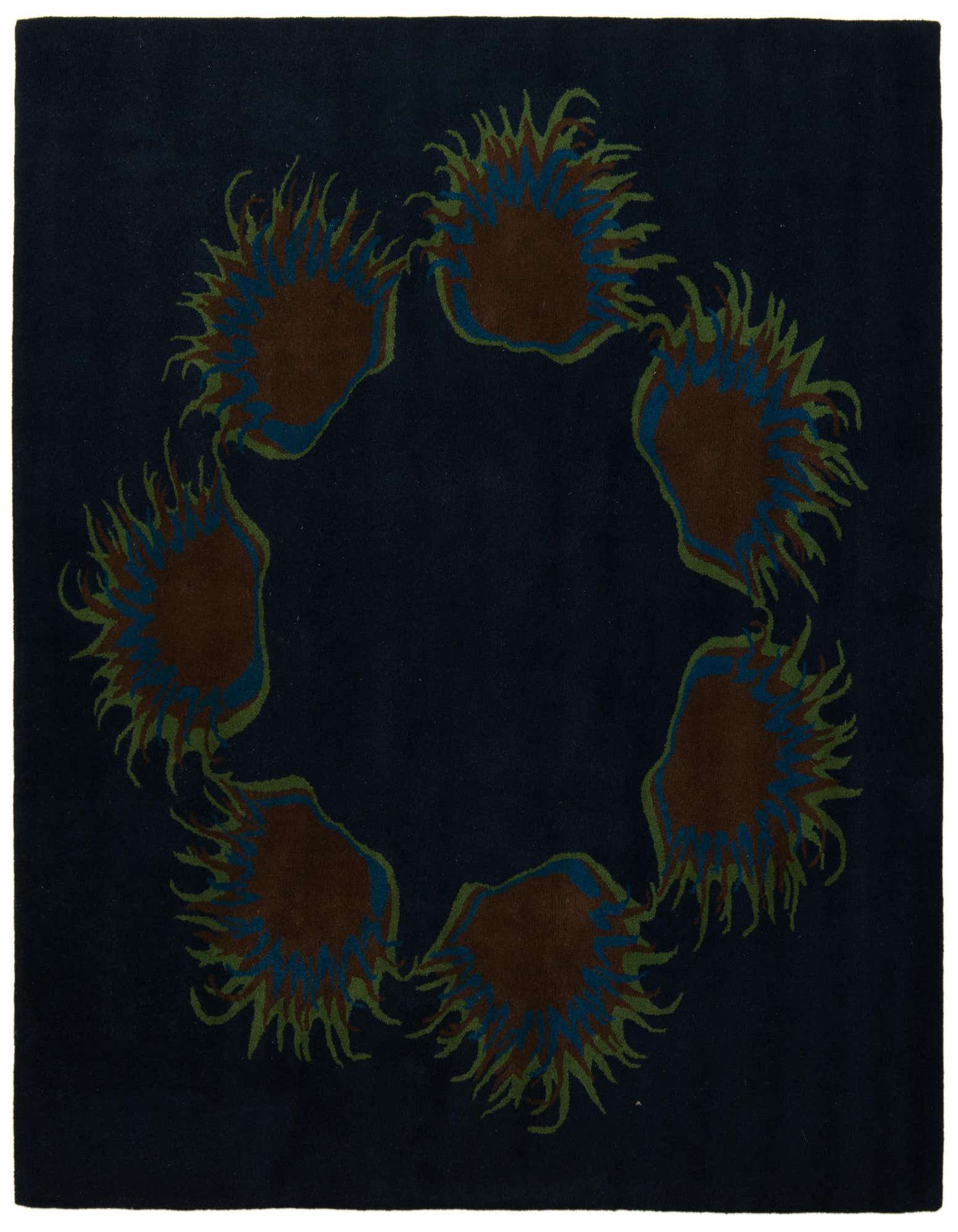 A square navy blue rug with a circular modern floral pattern of brown, blue, and green spiky shapes.