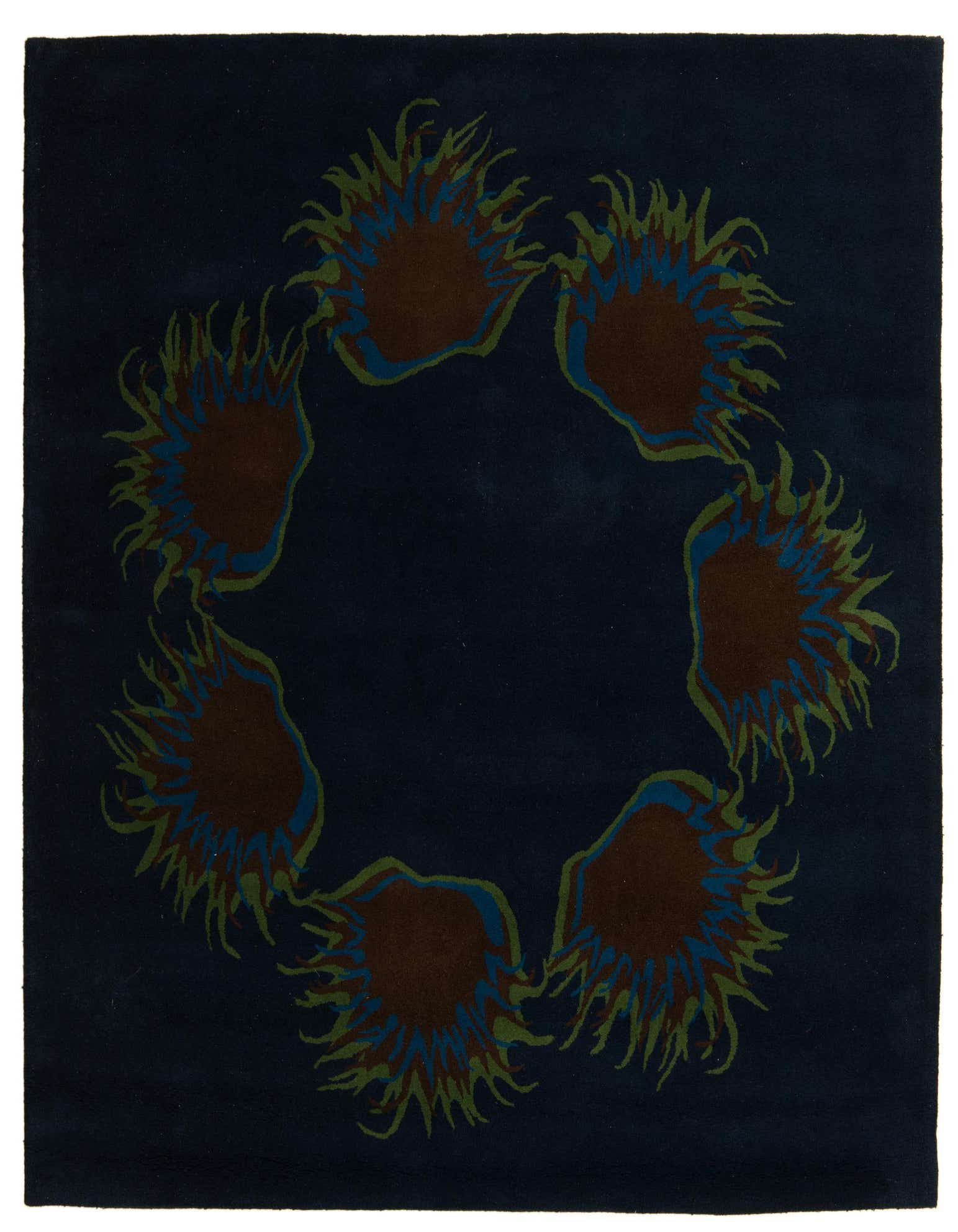 A square navy blue rug with a circular modern pattern of abstract brown, blue, and green shapes.