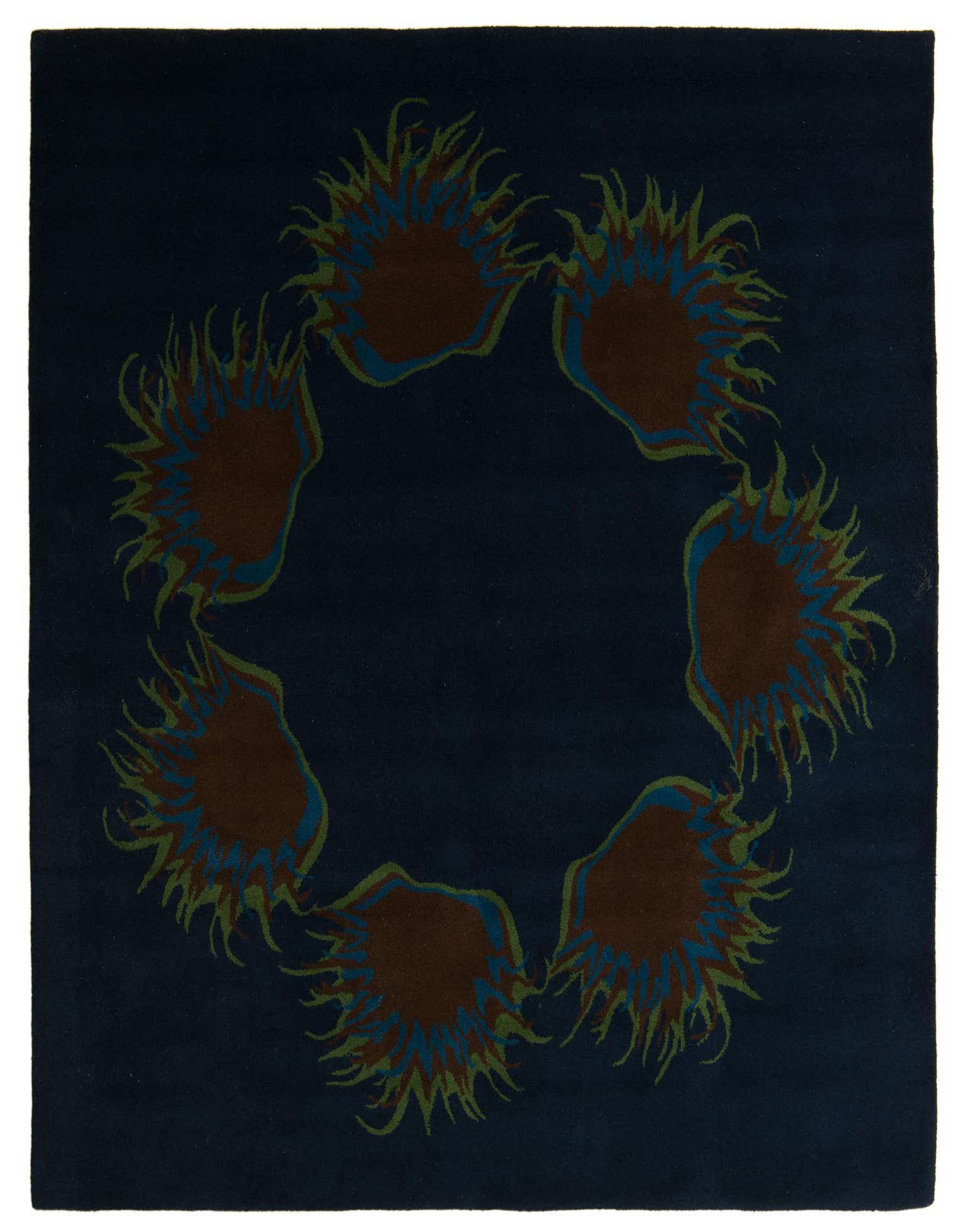 A square navy blue rug featuring a modern circular pattern of abstract brown, blue, and green shapes with spiky edges.