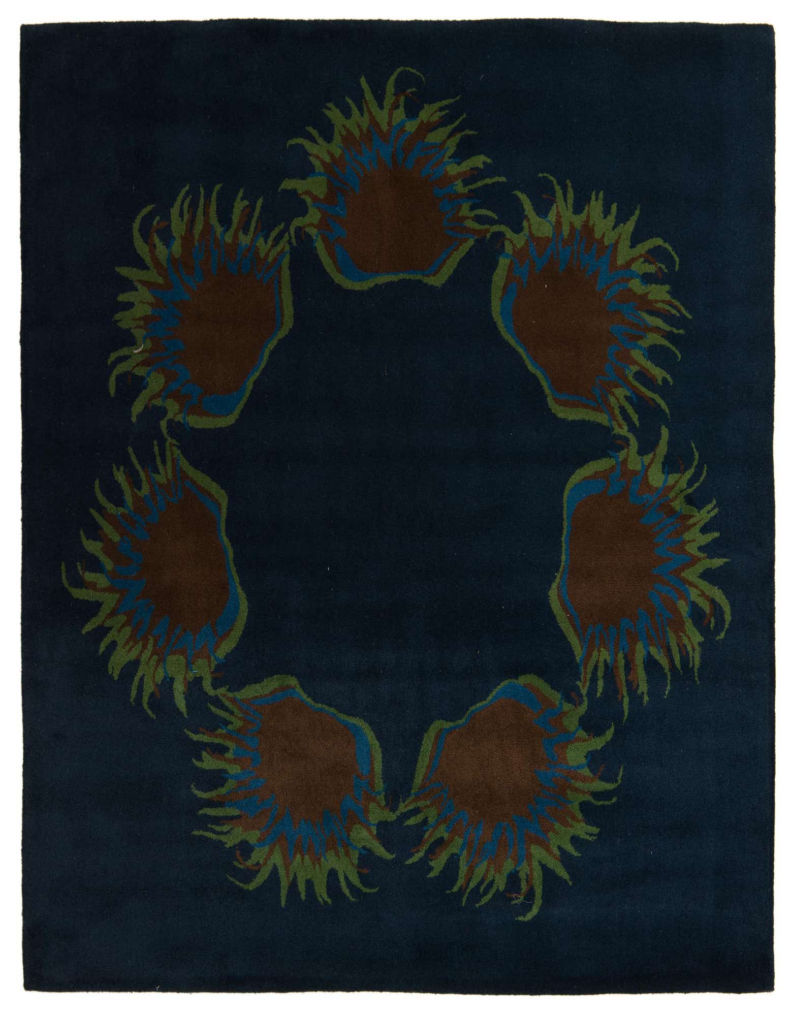 A square navy blue modern area rug with a circular pattern of brown, blue, and green abstract floral shapes.