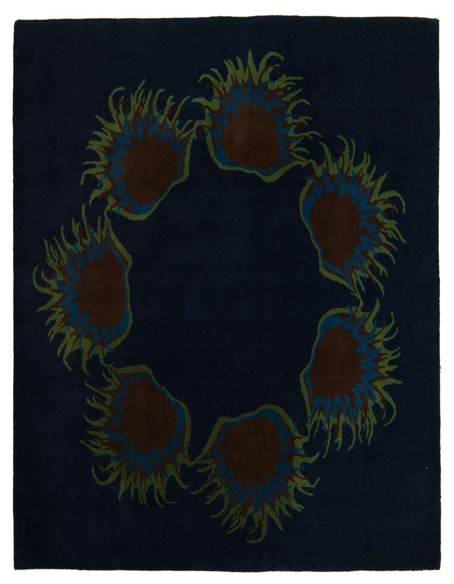 A square navy blue wool rug featuring a circular modern floral pattern in brown, teal, and olive green.