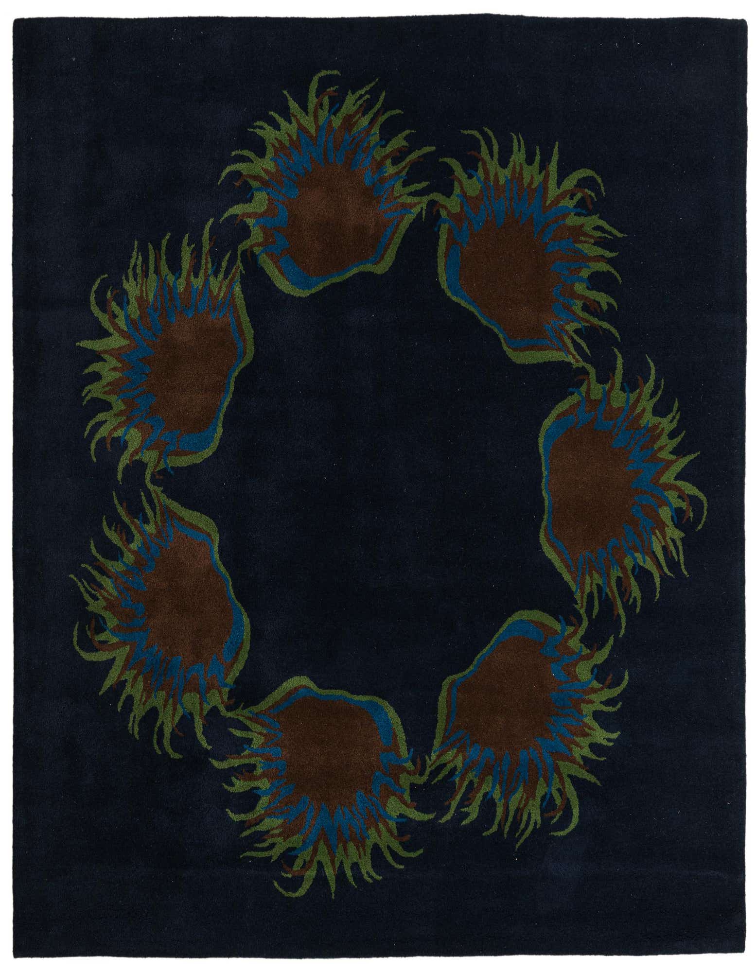 A square navy blue wool rug featuring a circular botanical pattern of brown, blue, and green floral bursts.