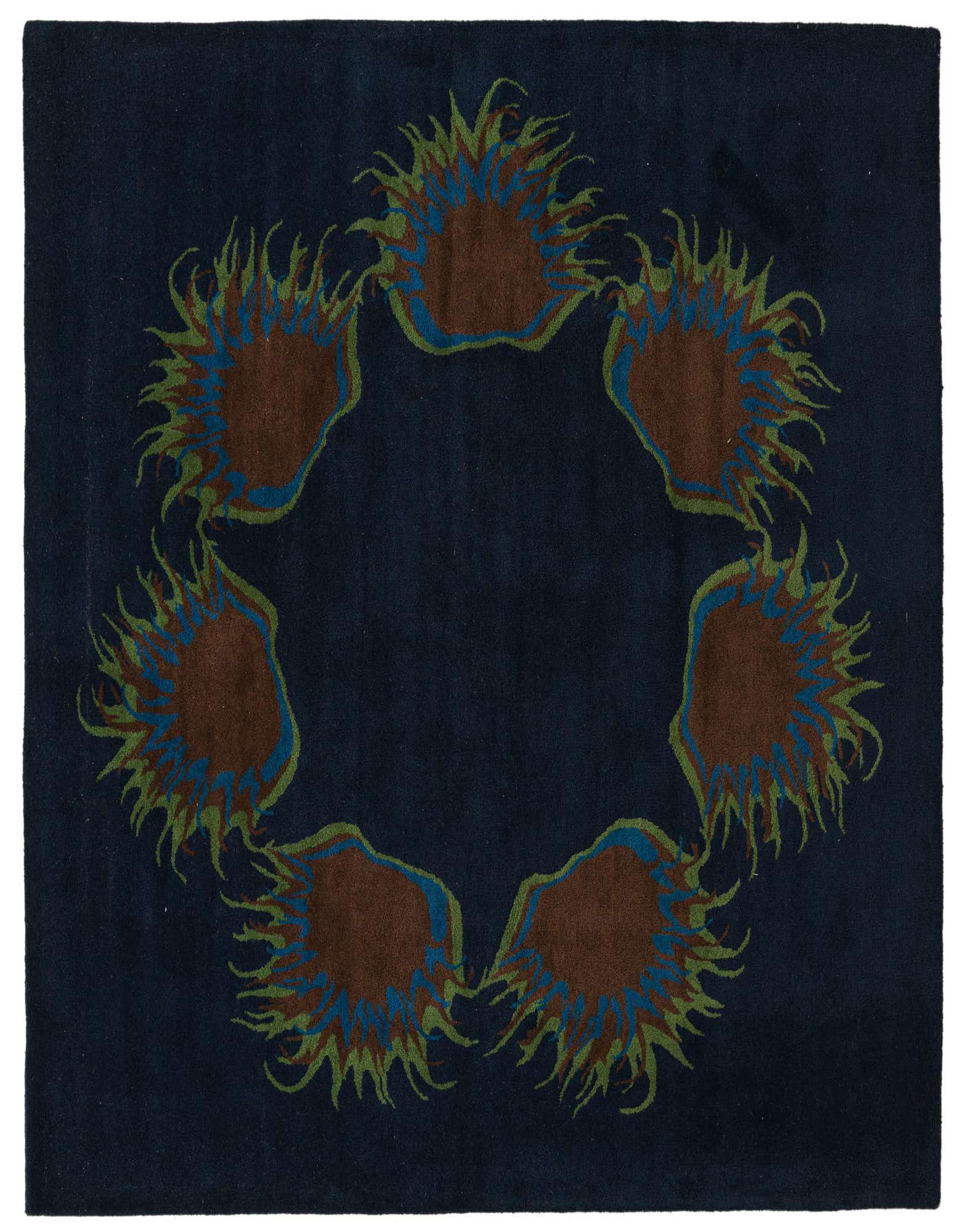 A square navy blue wool rug with a high pile, featuring an abstract circular pattern of brown, blue, and green shapes resembling sea anemones.
