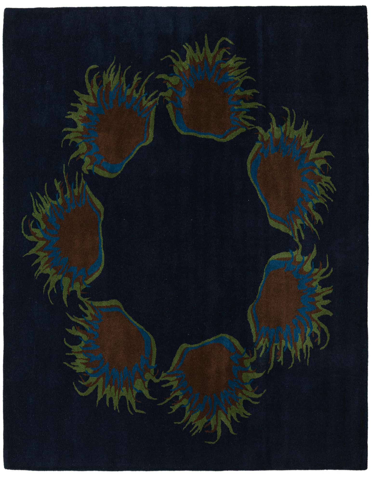A square navy blue wool rug featuring a circular arrangement of abstract floral motifs in brown, blue, and green.