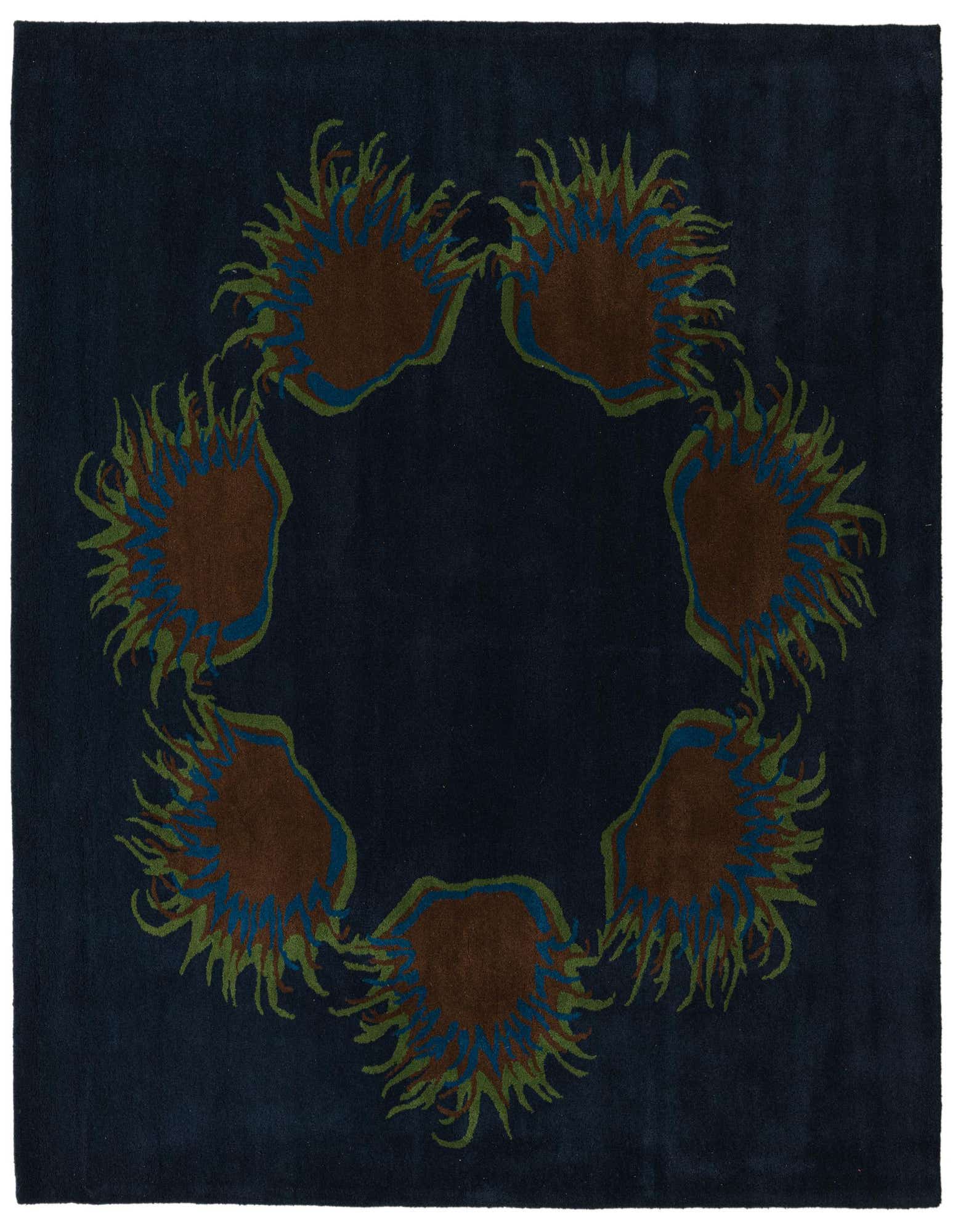 A square navy blue wool rug featuring a circular arrangement of six abstract brown, blue, and green floral motifs.