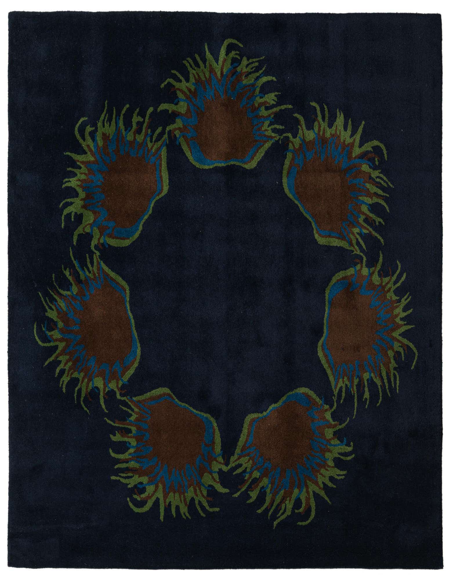 A square navy blue wool rug featuring a circular arrangement of abstract floral motifs in brown, blue, and green.