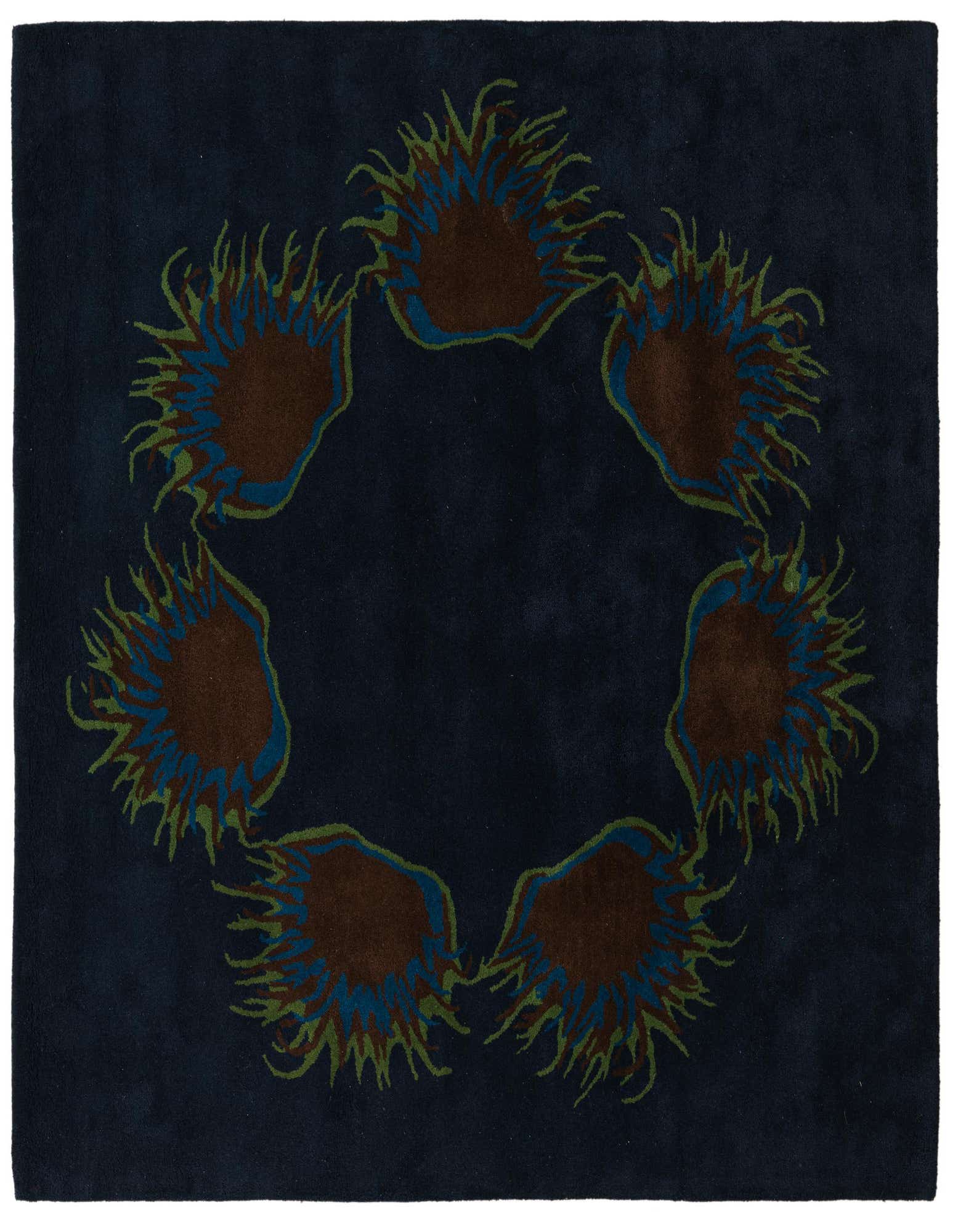 A square navy blue wool rug with a central circular floral pattern featuring brown, blue, and green botanical elements.