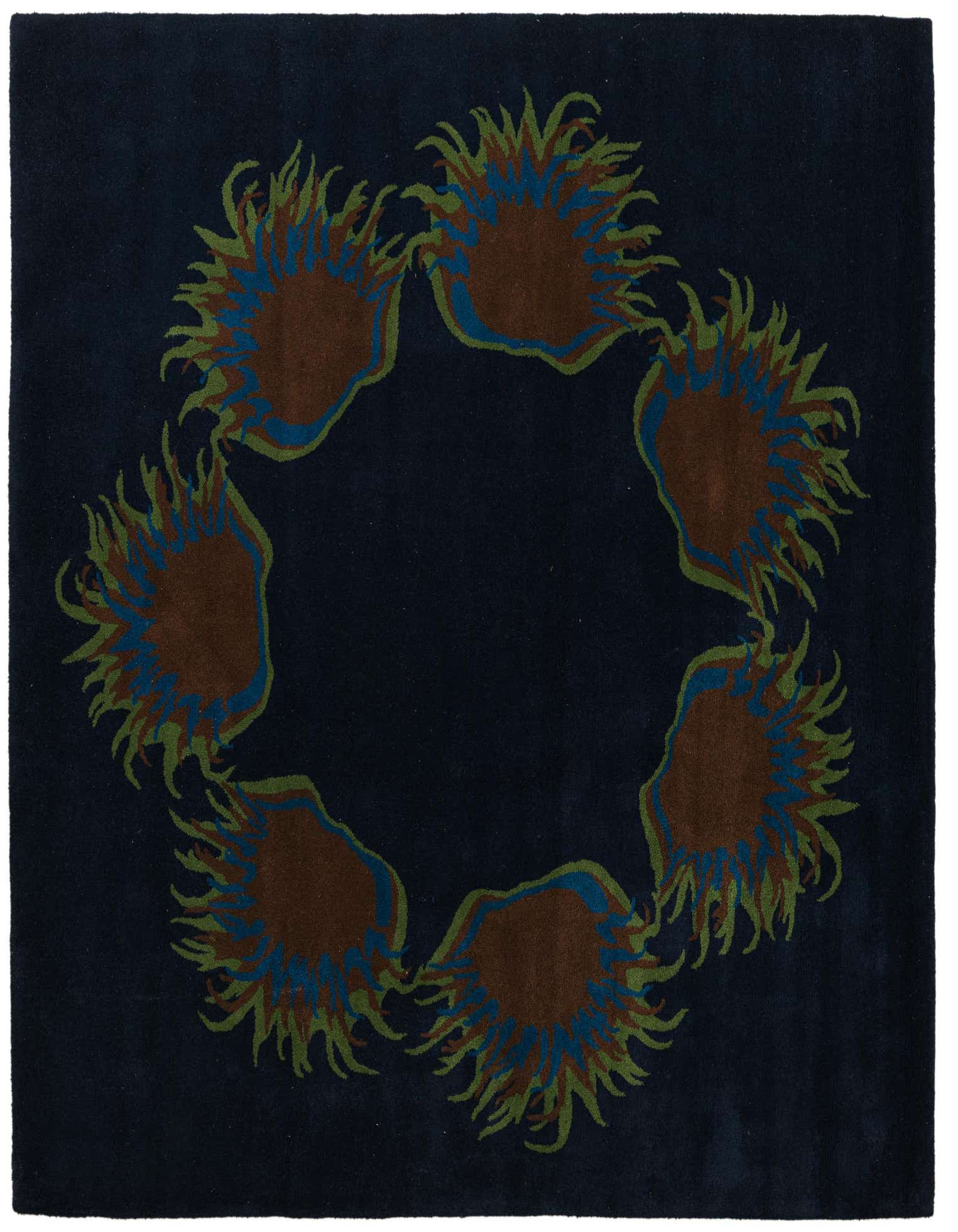 A square navy blue wool rug with a circular floral pattern of brown, blue, and green botanical shapes.
