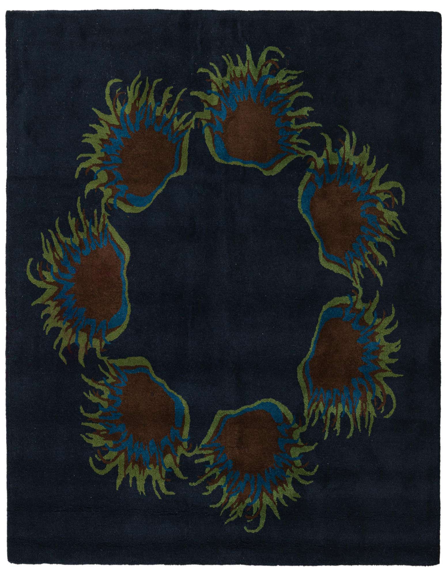 A square navy blue wool rug with a high pile, featuring a circular floral pattern of brown, blue, and green botanical shapes.