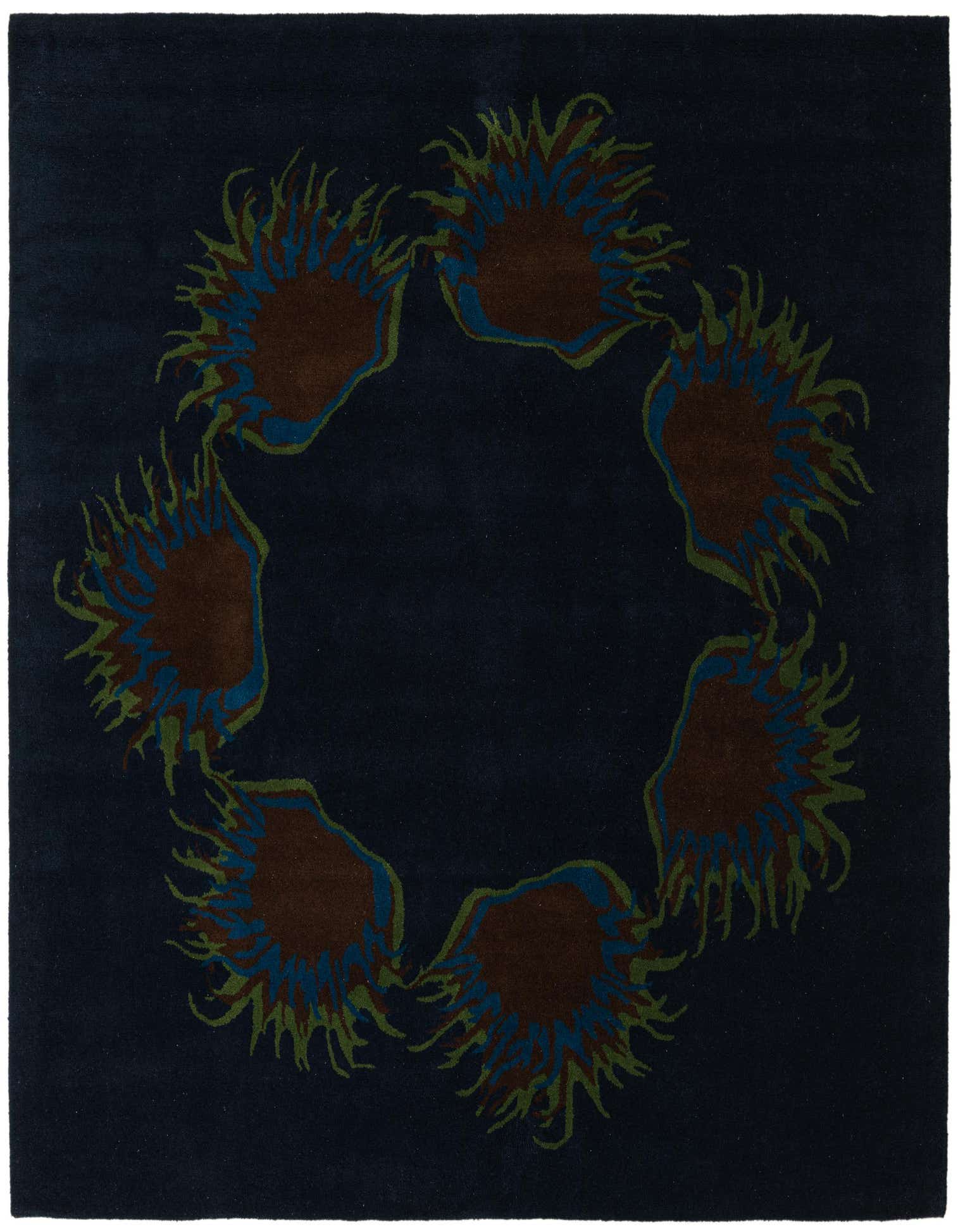 A square navy blue wool rug featuring a circular arrangement of abstract floral patterns in brown, blue, and green.