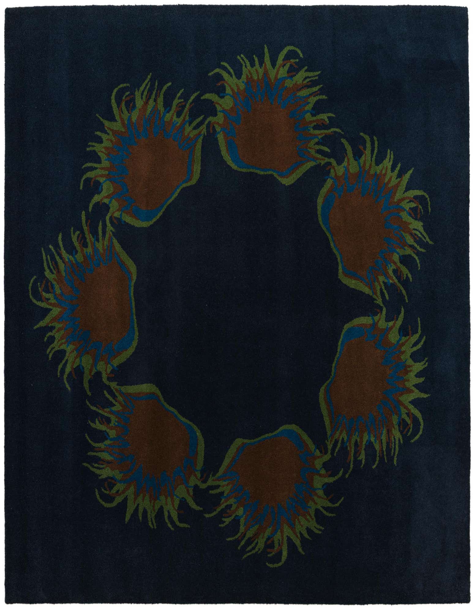 A square navy blue wool rug featuring a circular arrangement of abstract floral patterns in shades of brown, green, and blue.