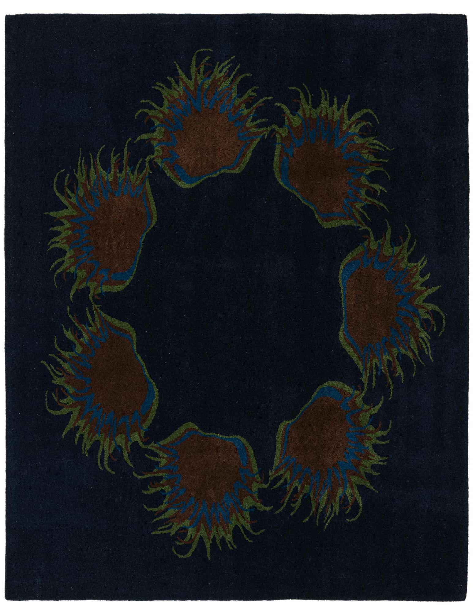 A square navy blue wool rug with a circular floral design featuring brown, green, and blue botanical shapes.