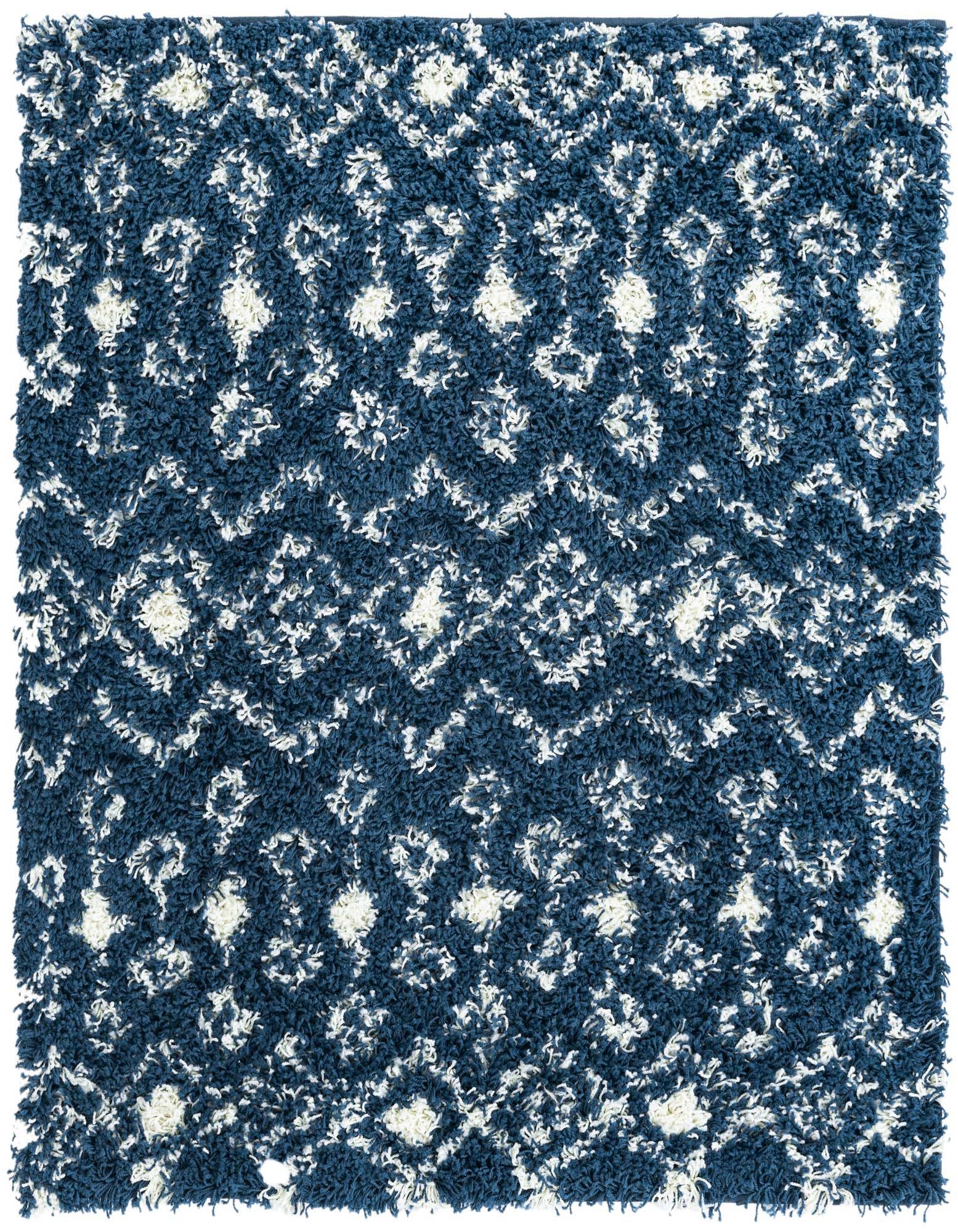 A square navy blue shag rug with a white tribal geometric pattern, featuring a soft, textured pile.