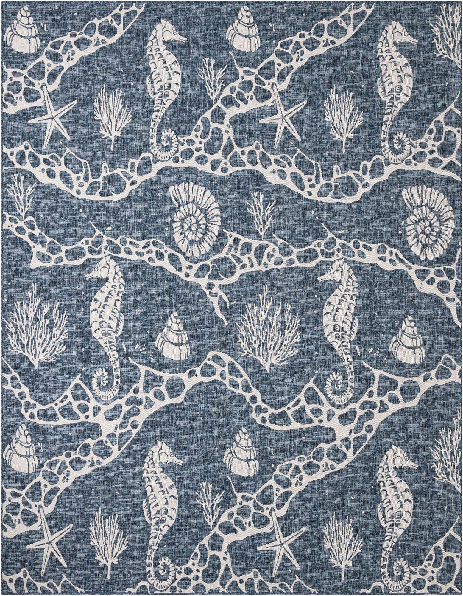 A square navy blue and white coastal rug featuring a pattern of seahorses, starfish, coral, and seashells.