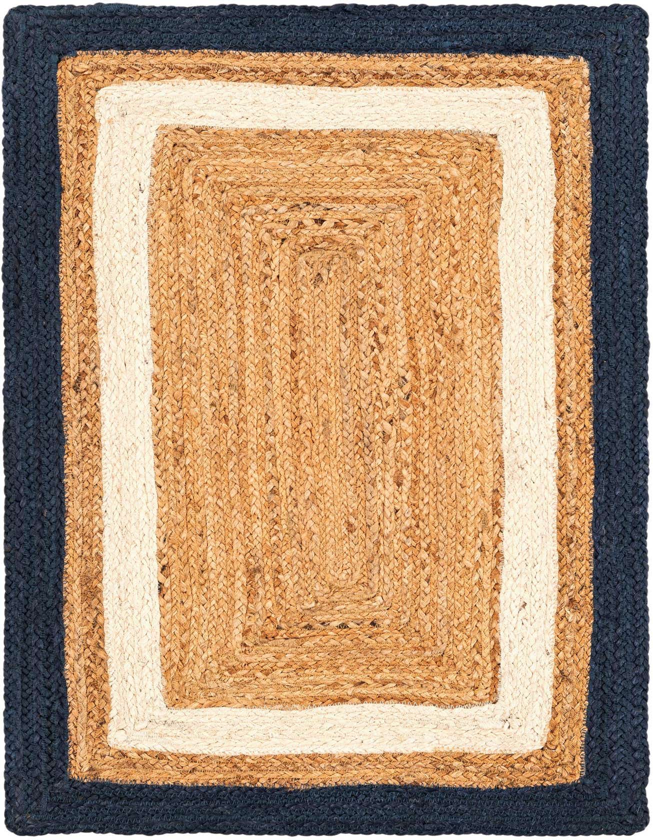 A 2x3 rectangular natural jute rug with a modern braided pattern featuring a navy blue border, an ivory stripe, and a tan center.