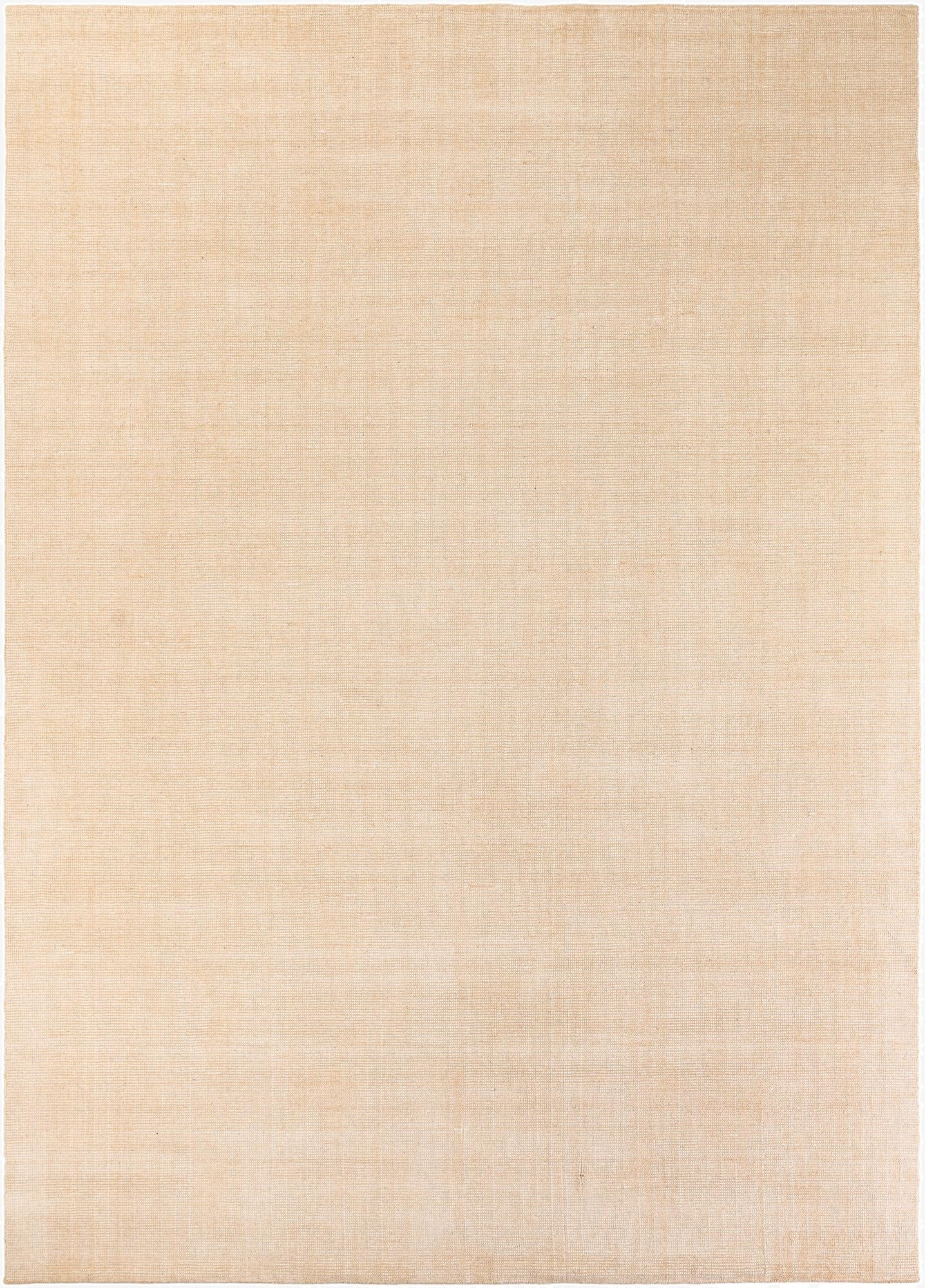 A large 10x14 rectangular Jill Zarin English Manor rug in a solid oat beige color, made of wool with a textured high pile.