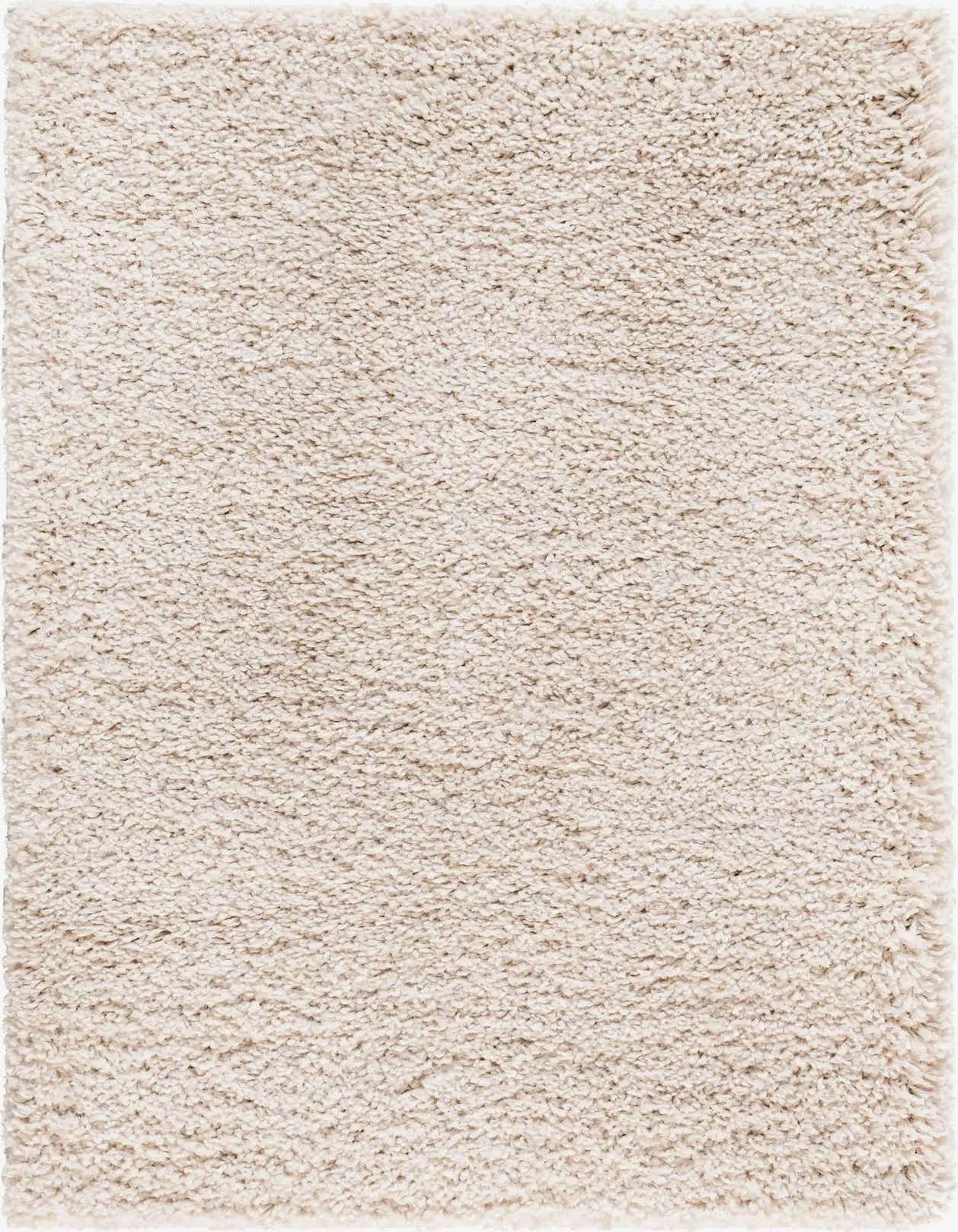 A close-up view of a rectangular 3x5 ivory shag rug, showcasing its soft, textured pile.