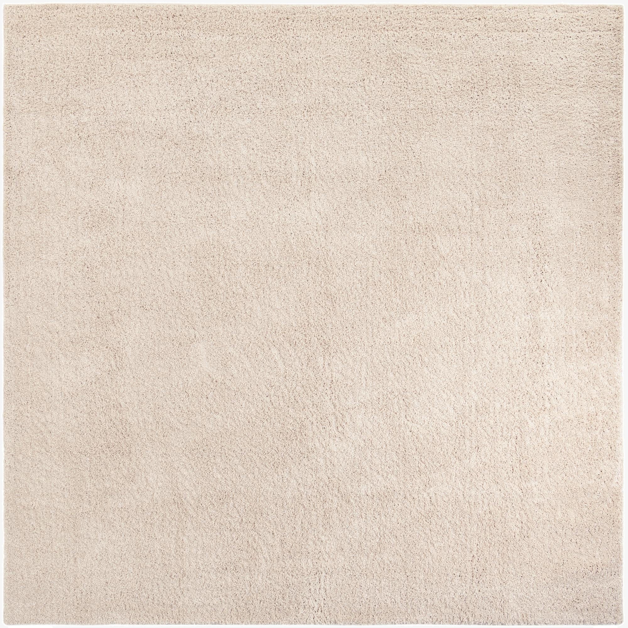 A 10'x10' square ivory shag rug with a soft, textured pile, suitable for a modern living room or bedroom.