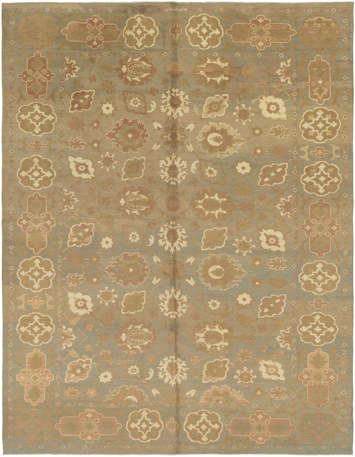 A large 13x18 rectangular Oushak rug in shades of green with transitional tribal and abstract patterns in beige and brown, suitable for a living room.
