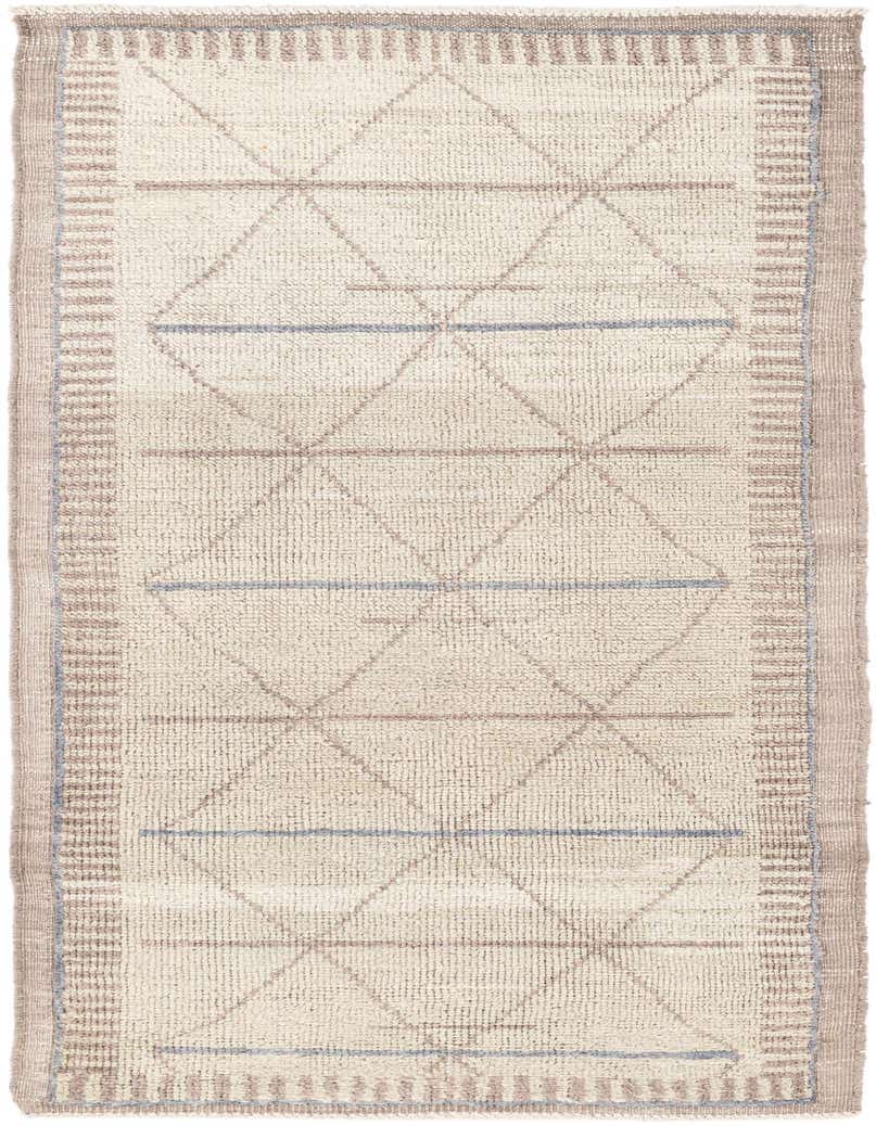 A 7 ft runner rug in a shag pile, featuring a modern tribal pattern with green diamonds and blue lines on a cream background, framed by a striped border.